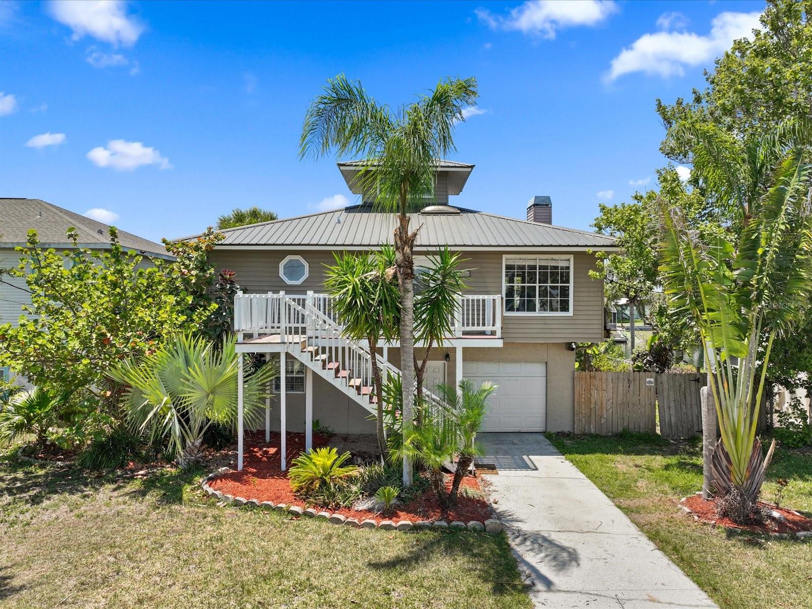 BACK UP OFFERS WELCOME! This is a Fixer Upper Home, but this home has great bones and a lot of character! This is a 3 Bedroom, 2 Bathroom, elevated, waterfront home, with indirect access to the Gulf of Mexico! Located in the popular Hernando Beach! Perfect as a primary, second home, or investment property. The canal side of this home faces west, so the views of the wide canal & sunsets are fantastic! The home has 60 feet on the canal, with a total of 6000 sq. ft of total lot.
The home features a very large, open floor plan of Kitchen, Living Room & Dining room. Giving all of this living area great views of the canal. The good size kitchen has all stainless, Samsung appliances & the Living room has a wood burning fireplace. It has a large master bedroom with an updated master bathroom that includes a walk-in shower, with shower seat & safety bars. A walk-in closet adjoins the bathroom. The 2nd bedroom faces the canal & the 3rd bedroom faces the road. The second bathroom is also tastefully updated & includes a skylight for extra natural light. The laundry room is located near the foyer / front door and includes a LG washer & dryer. From the open floor plan area you can access the unique widows peak area one level up. It's adorable, nautical rope stairs lead you to a spectacular view in all directions. Especially to those beautiful sunsets on the Gulf of Mexico! The couch upstairs conveys with the home.
There are lots of porches! A large porch is located on both the front & back on the main level. The back porch is screened in & overlooking the water. On the bottom level, there is a smaller brick porch area leading into the front of the home & a much larger porch overlooking the water on the canal side. Partially under cover & partially open. A large wooden deck for entertaining which also has a tiki hut frame, in need of repair, The wooden porch has an opening over the water where prior occupants jumped off into the water. From this area you can continue to a lower level to a stationary dock for launching your kayaks or tying up your pontoon or boat.
Not included in the square footage is a semi finished lower level, it requires a lot of TLC but adds approx. 700 sq. ft. This area is cooled with a portable LG- AC system & a wall unit that also conveys with the home. In addition, this home features a one car garage & a long driveway that can accommodate up to 3 additional cars.
Home upgrades include a Metal roof (2016 ), AC that is elevated to the 2nd level (Rheem 2016) & 2 updated bathrooms.
This home is on a spring fed freshwater canal that has indirect access to the Gulf of Mexico. To reach the Gulf your boat must go through a lift to a Saltwater canal then under a fixed bridge to the Gulf. Or you can dry dock your boat at any nearby, reasonable marina.
The home unfortunately has been neglected a little, so does need some TLC, but an opportunity to make it your own style & character! If you are looking for a waterfront home, in adorable Hernando Beach with NO HOA's and access to the Gulf of Mexico with a little TLC -this may be your dream home! Come check out this home today. Selling AS IS only. NO repairs will be done. Cash & Conventional only. Sale is subject to final approval by the Fifth Circuit Court of Hernando County. Buyers to verify all information.