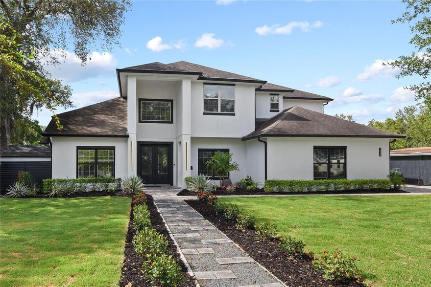 This custom 2014 built Winter Park residence is stretched over a double lot with a backyard resort style retreat yet close to all that Winter Park offers. A home with function and flexibility with a separate guest house, office or studio based on your needs. This thoughtfully designed home is sophisticated with casual comfort and showcases four bedrooms, 3.5 baths and nearly 3,800 square feet, downstairs main and additional guest suite, and upstairs includes remaining beds and baths. An inviting foyer welcomes you with volume ceilings, wood floors and a large transom window that allows beautiful natural light in. The family room is spacious with a marble wrap electric fireplace with lighting detail and niche for a flat screen TV. Clear glass doors across the back of the house lead you to the outside covered porch for ease of entertainment. The kitchen is open, light and bright with 42-inch shaker double stack cabinetry, large pantry and great workspace, a peninsula with bar seating as well as an eat-in kitchen area for large gatherings. Stainless appliances, granite counters and creative backsplash round it all out. The oversized laundry room includes an extra refrigerator and a second pantry for added convenience. The dining with tray ceiling, designer fixture and textured wallpaper add to the style of the home as well as dedicated office or flex space. Luxury continues into a primary suite with built-ins, large spa-like bath with sleek finishes, soaking tub, large dual-head shower and spacious walk-in closet. The primary suite overlooks backyard and opens to outdoor oasis with open air lanai with generous covered porch to gather or enjoy a night of alfresco dining. State-of-the-art modern resort style pool with heated spa, sun shelf with fountain feature, a fire feature runs along edge of pool and transforms the backyard into a luxurious tropical oasis particularly at night. Hardscaping elements include pathways trimmed with turf grass, professional landscape lighting that enhances and elevates the home. Don’t wait to tour this special home in the heart of Winter Park, close to the best schools with Lakemont Elementary, Glenridge Middle and Winter Park High. A mile from Park Avenue, close to hospital and walkable to the YMCA, Phelps Park and fantastic restaurants.