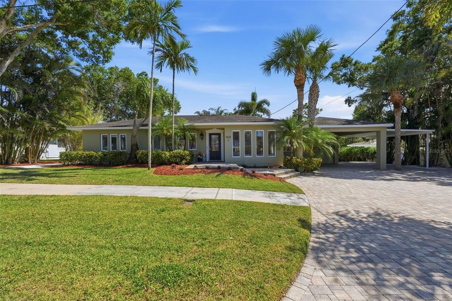 Welcome to this exceptional four-bedroom, three-bathroom home in Tarpon Springs offering 2,973 square feet of beautifully updated living space in a desirable non-flood zone. The property features an ADU out back and main house updates include an A/C installed in September 2025, Patriot air scrubber system for improved indoor air quality, new electric tankless water heater, new breaker panel installed in July 2025, Rinnai gas tankless water heater, and newly installed propane tank and lines in September 2025. From the moment you arrive, the large pavered driveway and three-car carport create impressive curb appeal, while peek-a-boo views of the bayou from the front of the home add to the coastal charm. Inside, the home showcases crown molding throughout, travertine flooring, and brand-new engineered hardwood flooring installed in 2025. Fresh paint and updated finishes complement the spacious layout, which includes an additional flex room, ideal for working from home, a media room, or additional guest space. The heart of the home is the gorgeous open kitchen designed for both entertaining and everyday living. Marble countertops, multiple breakfast bars for casual dining, a center prep island, abundant cabinetry, and a coffee bar with wine fridge create a luxurious and functional space. Premium appliances include a Frigidaire Gallery induction cooktop with fast boil technology and a Bosch fast-heat oven for quick preheating and efficient cooking. The spacious primary suite offers a relaxing private retreat with direct access to the outdoor patio through a set of French doors. The bedroom features a ceiling fan, walk-in closet with organizers, and a conveniently located washer and dryer. The en-suite bathroom includes a double-sink vanity and an oversized glass-enclosed shower with dual shower heads and built-in bench seating. The second bedroom also features its own attached private bathroom, offering excellent flexibility for guests or multi-generational living. Designed for year-round Florida enjoyment, the private pool can also function as a hot tub, creating the ultimate backyard oasis for entertaining or relaxing. Two fireplaces, one in the living room and another in the family room, add warmth and character throughout the home. The additional dwelling unit is equipped with a ductless mini-split A/C, dehumidifier, wine fridge, extensive custom cabinetry, and abundant storage space, providing excellent versatility for guests, hobbies, or a private retreat. Ideally located just minutes from the famous Tarpon Springs Sponge Docks, residents can enjoy local dining, boutique shopping, waterfront attractions, parks, and nearby golf courses. Outdoor enthusiasts will also appreciate close proximity to Fred Howard Park and Sunset Beach for boating, beaches, and spectacular Gulf Coast sunsets. This remarkable home offers an incredible opportunity to enjoy luxury living in one of Tampa Bay’s most charming coastal communities. Schedule your tour today!