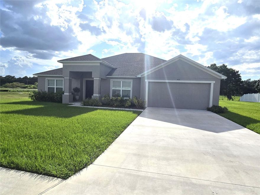 YOUR DREAM HOME!!! 4 bedrooms on over a half acre!  2024 SOUTHERN HOMES build that actually provides a YARD - none of that 10' between houses!  Cement block with stucco provides a beautiful home!  Hip Roof helps with the Wind Mitigation for home owners insurance! Over 2200 square feet of living space with a split-floor plan.  Delightful Kitchen with ample prep space and a walk-in pantry, a laundry room between the kitchen and garage, and the garage is a 2-car with electric overhead door and attic storage.  Electric box is in the garage and is 200 amp service.  The open floor plan lets you enjoy the family in the great room while busy in the kitchen.  Granite counter tops!  The oversized primary bedroom is only out done by the AMAZING walk-in closet accessed from the en-suite primary bathroom.  You gotta see this to believe it - almost 4 separate spaces in here!  Laminate floors through out except the bedrooms - carpeting for all!  This location is serene yet close to everything, true neighborhood - with sidewalks, minimum HOA fees, a perfect blend of spaciousness, comfort, and affordability!  Each bedroom provides the space to be enjoyed instead of "just a bed", the Great Room is open and provides a sliding door out the yard.  Entry provides a foyer that is open to the dining room, but private to the rest of the house.  Calming color scheme lets you enjoy from the moment you move in!