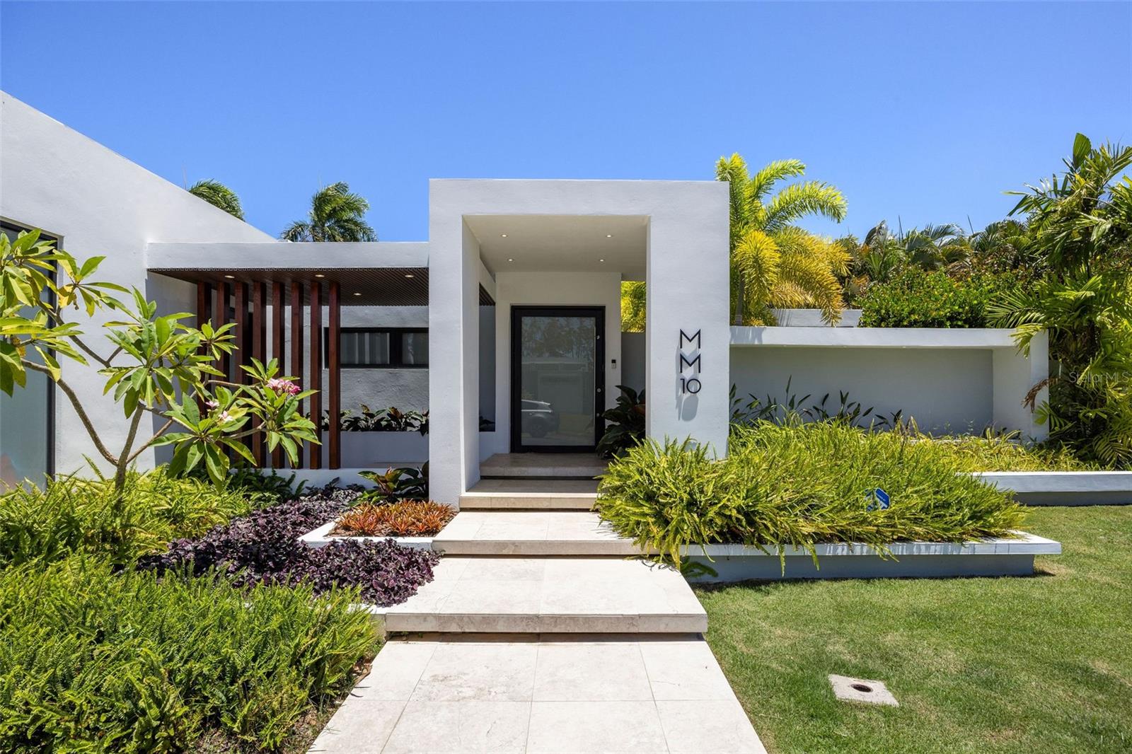 A one-of-a-kind residence where lush gardens and refined interiors blend seamlessly to create an atmosphere of privacy, comfort, and style. Nestled on a 670 sqm lot within the exclusive gated community of Dorado del Mar, this 3-bedroom, 4-bath estate was thoughtfully designed with impeccable attention to detail. Completely remodeled in 2022, the home has marble floors all throughout, a modern kitchen with an oversized island and top-of-the-line appliances, open spaces, and recessed lighting and a master bathroom that screams relaxation. Sliding doors open up all throughout, making it great for gatherings, while offering natural light and cross ventilation. Additional features include brand new electrical and plumbing systems, full power gas generator, roof treatment, and 2-car garage with high ceilings that can function as additional storage space. The property offers space to accommodate a 4th bedroom, and renderings are available upon request.
Situated just 30 minutes from San Juan, Dorado del Mar combines peacefulness with the charm of a town, making it an attractive destination for families and investors alike. The community itself boasts amenities such as a casino, restaurants, bowling alley, golf course, pickleball court, steps to the beach, and much more!