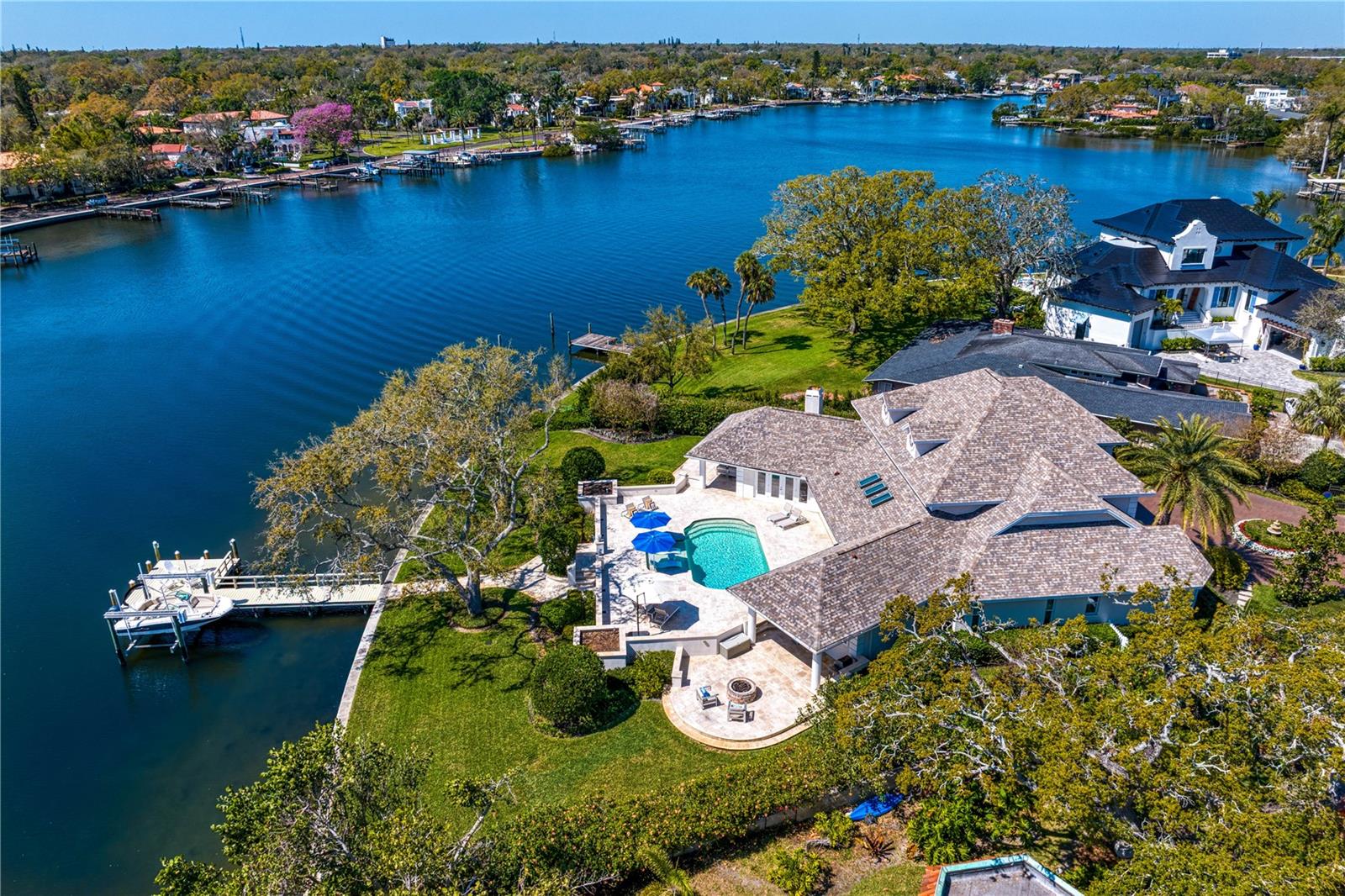 Rare Waterfront Gem on Snell Isle – Unmatched Views & Prime Location
Situated on one of the larger waterfront lots in Snell Isle, this breathtaking estate is located on the highly sought-after Coffee Pot Riviera, a private, brick-lined cul-de-sac. Spanning just over a half of an acre with 165+ feet of waterfront on a 200+ feet deep lot, this concrete block home offers an unparalleled blend of luxury, space, and the true Florida lifestyle. Exceptional Design & Layout! From the moment you step inside, you’ll be captivated by the stunning panoramic water views, visible from nearly every room. The 14-foot ceilings on the first floor create an open, airy ambiance, while the thoughtful floor plan seamlessly blends indoor and outdoor living. The outdoor space is unmatched, featuring:
• A sprawling backyard with plenty of room for people, parties, pets, or even a private soccer or volleyball field. ;)
• A huge pool deck with a covered dining area, ideal for entertaining.
• A cozy firepit, perfect for cool Florida evenings.
• A boat lift and large dock, ideal for manatee and dolphin watching or launching your boat.
• A covered outdoor living space with wood plank inlay, seamlessly extending from the family room for year-round enjoyment.
Smart, Spacious Living
The home’s versatile layout offers privacy and functionality, with:
• A primary suite on the first floor, along with a second bedroom (or office) and full bath.
• Additional guest bedrooms upstairs, plus double desks, a library, or office space—perfect for remote work or study.
Meticulously Maintained with Modern Updates
This home has been thoughtfully upgraded, ensuring peace of mind for years to come:
• Roof: 2014
• HVAC systems: 2022, 2024, and 2015
• Tankless hot water heater: 2024
• Kitchen appliances: 2021
• Washer/dryer: 2024
• Pool retiled & extended: 2018
• New pool heater/chiller: 2025
• Pool pump: 2018
• New 1st-floor flooring: 2022
• Hurricane windows & doors: 2018
• Dock & lift: 2015 | Dock pilings wrapped: 2020
• Seawall: 2017
• Sprinkler system: 2024
• Whole house painted: 2021
All of this, just a short walk along the waterfront sidewalk to downtown St. Pete, where you can enjoy world-class dining, shopping, and entertainment. Don’t miss this rare opportunity to own a one-of-a-kind waterfront estate in one of St. Petersburg’s neighborhoods.