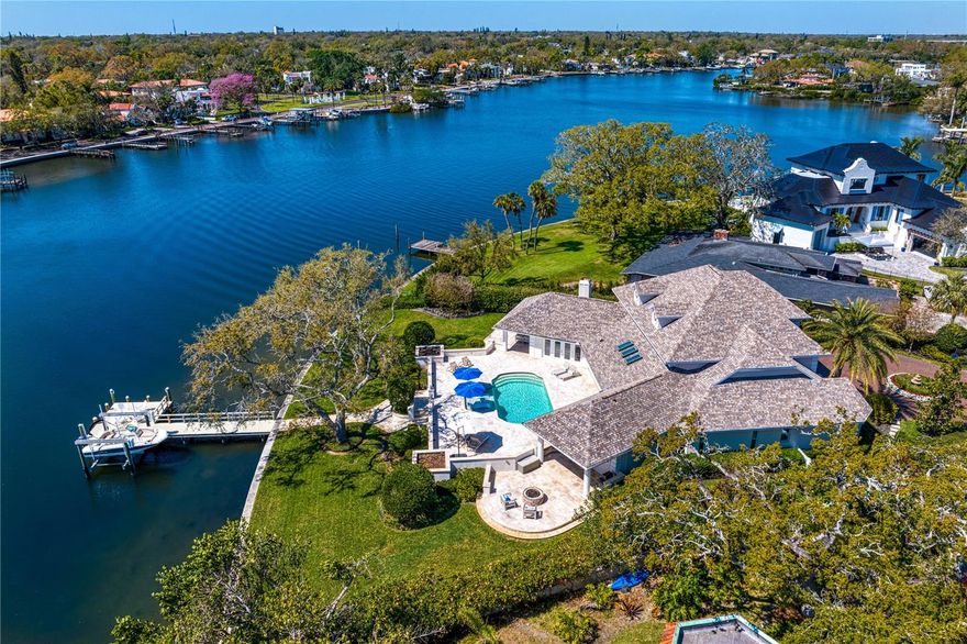 Rare Waterfront Gem on Snell Isle – Unmatched Views & Prime Location
Situated on one of the larger waterfront lots in Snell Isle, this breathtaking estate is located on the highly sought-after Coffee Pot Riviera, a private, brick-lined cul-de-sac. Spanning just over a half of an acre with 165+ feet of waterfront on a 200+ feet deep lot, this concrete block home offers an unparalleled blend of luxury, space, and the true Florida lifestyle. Exceptional Design & Layout!  From the moment you step inside, you’ll be captivated by the stunning panoramic water views, visible from nearly every room. The 14-foot ceilings on the first floor create an open, airy ambiance, while the thoughtful floor plan seamlessly blends indoor and outdoor living. The outdoor space is unmatched, featuring:
• A sprawling backyard with plenty of room for people, parties, pets, or even a private soccer or volleyball field. ;)
• A huge pool deck with a covered dining area, ideal for entertaining.
• A cozy firepit, perfect for cool Florida evenings.
• A boat lift and large dock, ideal for manatee and dolphin watching or launching your boat.
• A covered outdoor living space with wood plank inlay, seamlessly extending from the family room for year-round enjoyment.
Smart, Spacious Living
The home’s versatile layout offers privacy and functionality, with:
• A primary suite on the first floor, along with a second bedroom (or office) and full bath.
• Additional guest bedrooms upstairs, plus double desks, a library, or office space—perfect for remote work or study.
Meticulously Maintained with Modern Updates
This home has been thoughtfully upgraded, ensuring peace of mind for years to come:
• Roof: 2014
• HVAC systems: 2022, 2024, and 2015
• Tankless hot water heater: 2024
• Kitchen appliances: 2021
• Washer/dryer: 2024
• Pool retiled & extended: 2018
• New pool heater/chiller: 2025
• Pool pump: 2018
• New 1st-floor flooring: 2022
• Hurricane windows & doors: 2018
• Dock & lift: 2015 | Dock pilings wrapped: 2020
• Seawall: 2017
• Sprinkler system: 2024
• Whole house painted: 2021
All of this, just a short walk along the waterfront sidewalk to downtown St. Pete, where you can enjoy world-class dining, shopping, and entertainment.  Don’t miss this rare opportunity to own a one-of-a-kind waterfront estate in one of St. Petersburg’s neighborhoods.