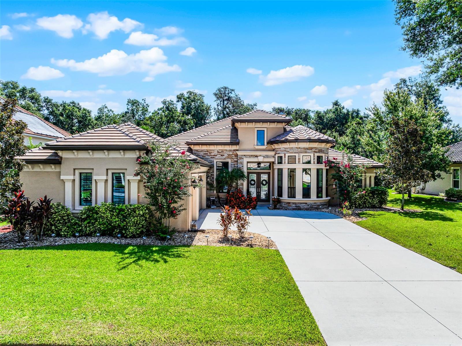 This 4-BEDROOM, 3-BATH CUSTOM-BUILT RESIDENCE by ICI HOMES offers the ultimate blend of LUXURY, COMFORT, and FUNCTIONALITY. Located in the highly desired, luxury Estate Enclave in The Sanctuary at Spruce Creek, this BLOCK HOME is tucked away on a PRIVATE CUL-DE-SAC in a GATED COMMUNITY, designed to impress from the moment you arrive.
Inside, you’ll find a thoughtfully crafted SPLIT-BEDROOM FLOOR PLAN with an OPEN-CONCEPT LAYOUT, filled with abundant NATURAL LIGHT streaming through ENERGY STAR QUALIFIED WINDOWS. The interior showcases SLEEK TILE-WOOD FLOORING, brand new carpets in the bedrooms, STONE DETAILING THROUGHOUT, and COFFERED CEILINGS that elevate the home’s architectural style.
The spacious KITCHEN-FAMILY ROOM COMBO is ideal for entertaining, featuring GRANITE COUNTERTOPS, abundant cabinetry, and a GAS COOKTOP. Outdoors, you’ll also find a SUMMER KITCHEN ROUGH-IN with a GAS LINE for added culinary flexibility. The inviting FAMILY ROOM boasts a COZY wood-BURNING FIREPLACE—the HEART OF THE HOME. A separate DEN/OFFICE provides the perfect space for work or retreat.
The PRIMARY BEDROOM offers a CUSTOM CLOSET, while BEDROOMS 3 and 4 also feature their own CUSTOM CLOSETS, ensuring exceptional storage throughout.
Outdoor living is redefined with a SALT WATER POOL and CONNECTED JACUZZI, surrounded by a WELL-MANICURED EXTERIOR. The COVERED BACK PATIO includes its own FIREPLACE and a MOTORIZED SCREEN that can be raised or lowered, plus OUTDOOR SPEAKERS as part of the WHOLE-HOUSE SOUND SYSTEM—perfect for gatherings.
Additional highlights include REMOTE-OPERATED BLINDS in the KITCHEN, LIVING ROOM, and MASTER BEDROOM, an ALARM SYSTEM, a 3-CAR GARAGE, and WATER ACCESS TO SPRUCE CREEK. With NO REAR NEIGHBORS and a LOCATION that keeps you close to MAJOR ROADWAYS, LOCAL SHOPS, RESTAURANTS, AND MORE—this home is the perfect combination of ELEGANCE, COMFORT, and CONVENIENCE.
Ready to welcome its new owners, this home checks every box for LUXURY LIVING in Central Florida!