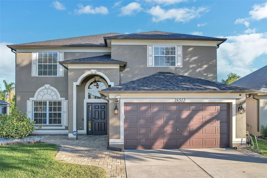 One or more photo(s) has been virtually staged. Move-in ready, this two-story home in Concord Station combines modern amenities with a prime location. With a roof updated in 2021 and a freshly painted interior, the house exudes a fresh and contemporary atmosphere. The floors are a mix of solid hickory wood in the common areas and soft carpeting in the bedrooms, offering both style and comfort.

A well-appointed kitchen lies at the heart of this home, featuring a suite of recent appliances under warranty, including a microwave, dishwasher, and refrigerator, all surrounded by an ample array of cabinets for all your culinary needs.

Entertaining is a breeze on the extended lanai, which boasts a propane outdoor kitchen, wine bar, and TV mount. Additional conveniences such as comprehensive guttering and an external hood vent reflect the home’s thoughtful design.

The community amenities at Concord Station are robust, with a clubhouse, fitness center, pool, splash pad, playground, and courts for basketball and tennis. The location is zoned for Oakstead Elementary, Rushe Middle School, and Sunlake High School, with Charter School Imagine School of  O' Lakes also within close proximity. This home is nestled in an area renowned for its top-rated schools and vibrant shopping and dining scene along Hwy 54. With less than a 30-minute drive to the airport and just 40 minutes from downtown Tampa, it offers the perfect blend of suburban peace with easy urban access.