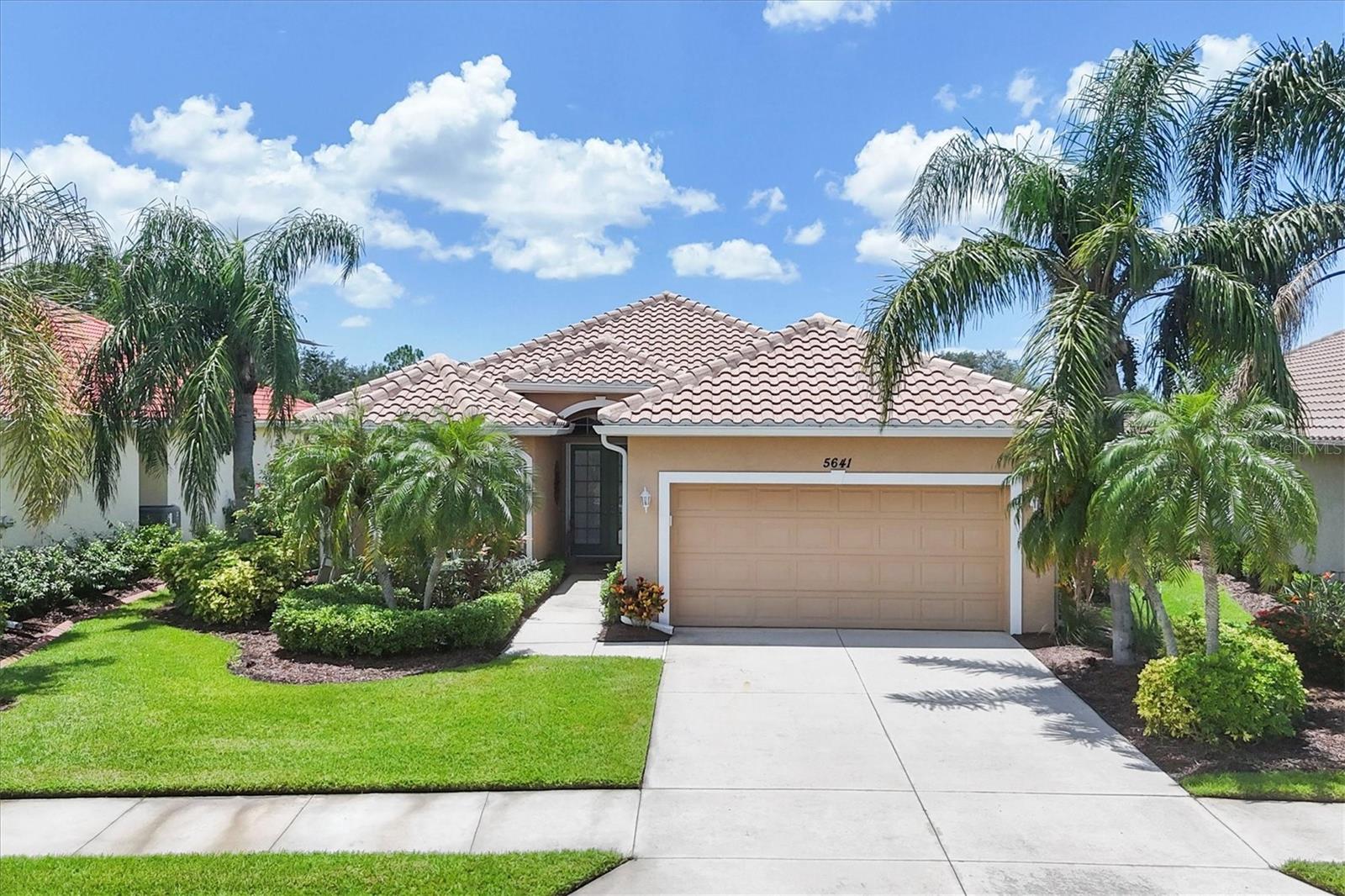 *HERON CREEK GOLF AND CC** Panoramic GOLF & WATER VIEWS | 3 Bed | 2 Bath | POOL AND SPA ! Welcome to "VISTA VERDE" this pristine and move-in-ready home is ideally positioned on an oversized lot overlooking the 6th fairway of the Oaks Course. With sweeping views of lush green fairways and sparkling water, this casually elegant retreat embodies the Florida lifestyle. Step through double glass entry doors into a light and airy interior where high ceilings, classic crown molding, and ceramic tile laid on the diagonal create timeless appeal. A fresh neutral color palette is beautifully accented with pops of succulent green, soft sage, sea glass and sand tones, all complemented by crisp bright trim and thoughtful architectural detailing. The popular “open concept” floor plan features a designated dining area spacious great room with a cascading wall of sliding glass doors that seamlessly blend indoor and outdoor living. The kitchen is as functional as it is stylish, boasting: Steepled cabinetry with abundant storage Solid surface countertops and generous workspace, Tumbled tile backsplash and under-cabinet lighting for ambiance, Slate appliance suite, Built-in desk and double-door pantry and a sun-filled dining nook framed by a charming 2-panel aquarium window. Guests will enjoy privacy with a full suite at the front of the home, while a third bedroom off the great room is ideal as a convertible home office, featuring a custom closet redesign—perfect for the “not-quite-retired” or work-from-home lifestyle. The primary suite is a true sanctuary, offering ample space for a sitting area, a large walk-in closet, direct access to the lanai, and an ensuite bath with: Oversized walk-in shower, Dual-sink vanity, Private water closet, and Generous linen storage closet. Step outside to a spacious covered lanai, perfect for relaxing or entertaining. Expand your shade with the motorized awning or take a dip in the heated pool and spa while soaking in unobstructed golf course views from the CLEARVIEW lanai screening. This home is move in ready, sports a NEW TILE ROOF(2024), Freshly epoxied garage floor, meticulously maintained systems, and her stylish furnishings will be available under separate contract. This home exudes a fresh, coastal, and casually elegant vibe—a true gem in one of North Port’s most desirable gated golf communities. Heron Creek offers exceptional amenities including a 21,000 sq ft clubhouse, 27 holes of Championship golf Arthur Hills design, resort style pool & spa, a robust social calendar, fitness center, Tennis courts & formal & casual dining options! *NO CDD FEES * LOW HOA FEES conveniently located w/easy access to I-75 & US-41, Cocoa Plum Shopping , WELLEN PARK, Braves Stadium, COSTCO & just 3 miles to the new 450 Million SMH Hospital Coming to I-75 / Sumter Blvd!