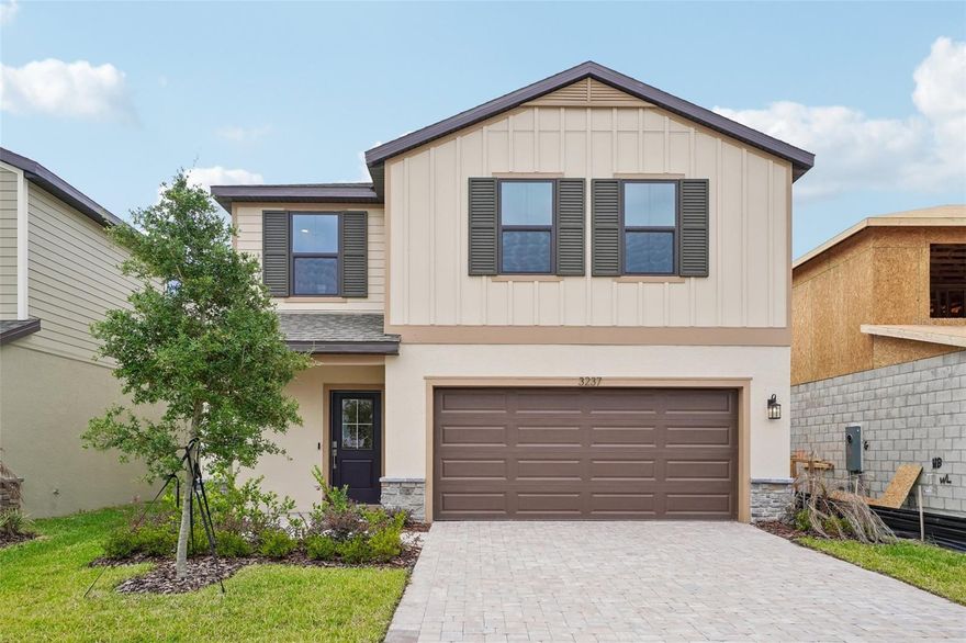 MOVE-IN READY! Welcome to this beautifully designed 4-bedroom, 3-bath, two-story home offering over 2,300 square feet of thoughtfully crafted living space. This residence blends modern finishes with a functional layout ideal for both everyday living and entertaining. The open-concept first floor features a spacious kitchen overlooking the café and family room, creating a seamless flow for gatherings. Interior highlights include 12x24 ceramic tile flooring in the main living areas and elegant 3cm quartz countertops throughout. A first-floor secondary bedroom and full bath provide the perfect setup for guests or a home office. Upstairs, you’ll find a versatile loft space perfect for a media room or additional lounge. The private primary suite offers a relaxing retreat with a large walk-in closet and a beautifully finished ceramic tiled shower. Additional bedrooms are well-sized and thoughtfully positioned for privacy, with ceramic tiled showers throughout the home’s bathrooms for a clean, upscale feel. Step outside to enjoy a large backyard with plenty of space to relax or entertain, along with a paver driveway and patio that enhance both curb appeal and outdoor living. The attached 2-car garage adds convenience and storage, while lawn care included in the HOA makes for easy, low-maintenance living. Ideally located in a sought-after community set on the Grasslands Golf Course, this home offers both lifestyle and convenience. You’re just minutes from Lakeside Village, Lakeland’s premier shopping, dining, and entertainment destination, as well as less than 5 minutes from the shopping center. Enjoy quick access to Lakeland Linder International Airport, and be just 10 minutes from the award-winning Bonnet Springs Park and vibrant downtown Lakeland.