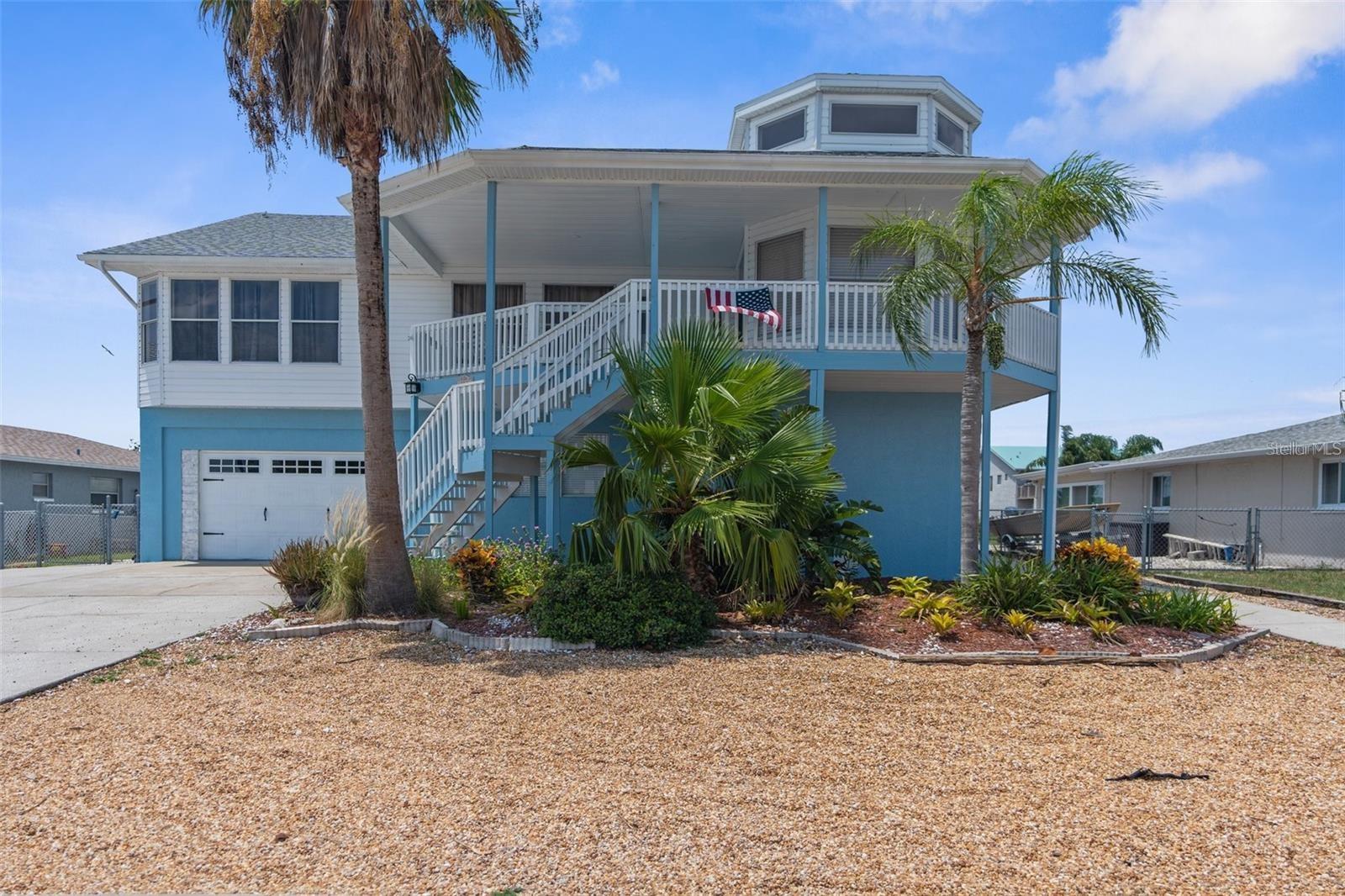Welcome to this stunning fully renovated waterfront home featuring six bedrooms and three bathrooms, perfect as a luxurious personal residence. RENTED FULLY FURNISHED! Located in a sought-after boating and golf cart community, the property offers direct Gulf access and breathtaking water views from your backyard. This two-level home provides ample space for relaxation and entertainment, with the ground floor offering three bedrooms, a large bathroom, a spacious living area, and a convenient kitchenette—ideal for guests or in law quarters. Upstairs, enjoy 2,005 square feet of elegant living space, including a master suite with a beautifully tiled en-suite bathroom and walk-in closet, plus two additional bedrooms and another full bathroom. The brand-new kitchen boasts Carrera countertops, new cabinets, stainless steel appliances, a wine cooler, and a massive walk-in pantry. Modern waterproof laminate flooring, a dramatic spiral staircase, and fresh paint inside and out add to the home’s contemporary charm. Additional upgrades include a new roof, updated fixtures, stylish lighting, and not one but two laundry rooms—one on each level. Step outside to enjoy front and rear porches, a private dock for boating enthusiasts, and a serene, picturesque setting. Conveniently located just a mile from boat ramps, grocery stores, and gas stations, and within close proximity to hospitals, gyms, restaurants, parks, and golf courses, this turnkey home truly offers the perfect blend of luxury, comfort, and convenience.