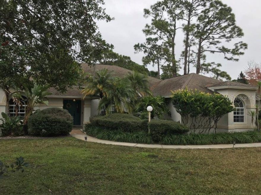 Perfect floor plan. Ideal location. And what a value!
With over half an acre, fruit trees, set aside garden and screened pool deck, the home's exterior highlights easy outdoor living with an added screened patio, oversized 3 car garage driveway and access to Sugar Mill's Country Club and world renowned Golf course.
Inside you will find volume ceilings and sky lights that maintain a bright open floorplan with the kitchen, massive living room and dining room overlooking the pool and screened patio. Tons of storage and an interior laundry room are but a few of the obvious conveniences that when added to the luxurious room sizes, enormous master bed and stately master bath (yes, that is a double jetted tub) combine to make the home an oasis. And so close to New Smyrna's beaches, nightlife, restaurants, shopping and entertainment. ;Water: City