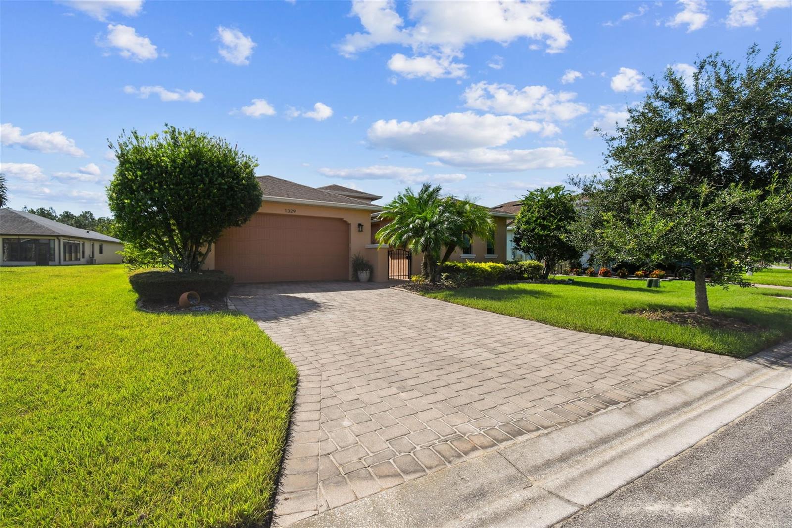 Welcome to this sought-after 2013 St. Augustine model, featuring 3 bedrooms, 3 bathrooms, a den/study, and a private casita/in-law suite—perfect for multi-generational living or hosting guests in style. Nestled on an extra-wide, custom-landscaped lot close to the Palms Resort Amenities Center, this home offers the perfect blend of privacy, comfort, and resort-style living. Enter through a charming gated courtyard and step inside through a leaded glass front door into spacious open-concept living areas. The chef’s kitchen features granite countertops, an eat-at bar, and abundant cabinet and counter space—ideal for cooking and entertaining. The large primary suite boasts a generous walk-in closet and a luxurious en-suite bath with granite counters and a walk-in shower with built-in seat. A second bedroom is tucked away on the opposite side of the home for privacy, adjacent to a full guest bathroom. The separate casita offers its own private entrance from the courtyard and includes a kitchenette, full bathroom with walk-in shower, and plenty of space—making it an ideal guest suite or private home office. Enjoy the flexibility of a dedicated den/study, and unwind in the screened, covered lanai complete with an included hot tub—the perfect spot to relax after a long day. Additional features include: 2-car garage with dedicated golf cart charging. Whole-house water filtration system and New HVAC system (2019). This thoughtfully designed home offers both luxury and practicality in one of the area's most desirable quiet neighborhoods. This beautiful home combines comfort, functionality, and a premier location. Solivita is renowned for its vibrant 55+ community, offering an array of activities and amenities tailored to active adults. Whether you’re enjoying a round of golf, engaging in fitness classes, or simply strolling along scenic walking paths, this neighborhood promotes an active and fulfilling lifestyle with over 230 clubs, sports, and activities to choose from. Enjoy the community’s clubhouse, softball field, 14 swimming pools, an indoor walking track and indoor pool, and much more. Every day offers something new to explore and enjoy! This home also features easy access to nearby shops, dining, and health care, offering the perfect balance of privacy and lifestyle.Don't miss out! Schedule your private showing today!