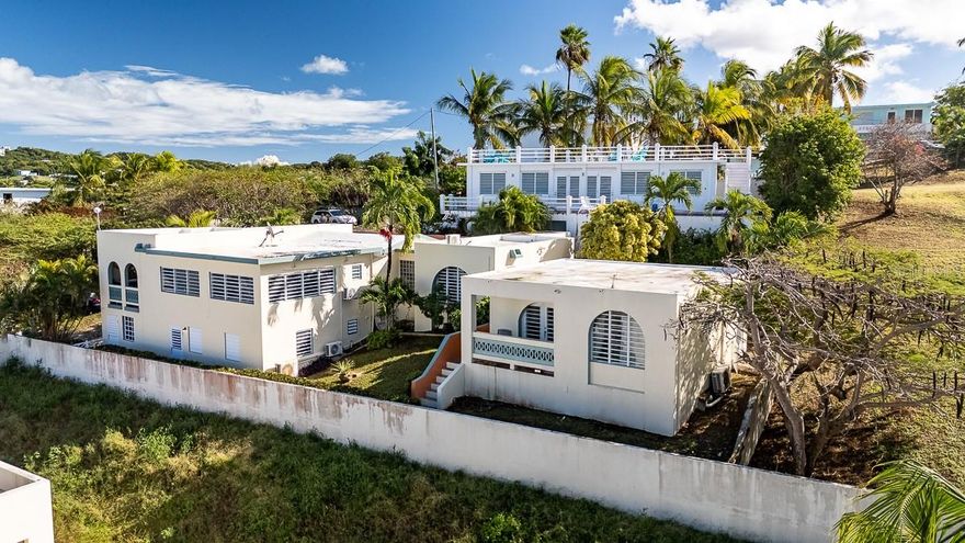 Excellent cash-flowing property now on the market in Bravos de Boston. Located on a quiet hillside street, the property has water views of the Atlantic Ocean and a strong long-term rental history.  Within a very short walk is La Chata beach.

The home consists of three separate apartments. The main level features a 2-bedroom, 2 and a half bath unit.  The ground level offers a 1-bedroom apartment, and a separate stand-alone casita provides an additional full 1-bedroom unit. All units are fully furnished and outfitted.

Additional features include a cistern, outdoor shower and sink area, and a large upper parking area. A solid opportunity for investors or buyers seeking a multi-unit property with income and ocean views in Vieques. Cap rate at 3.88.