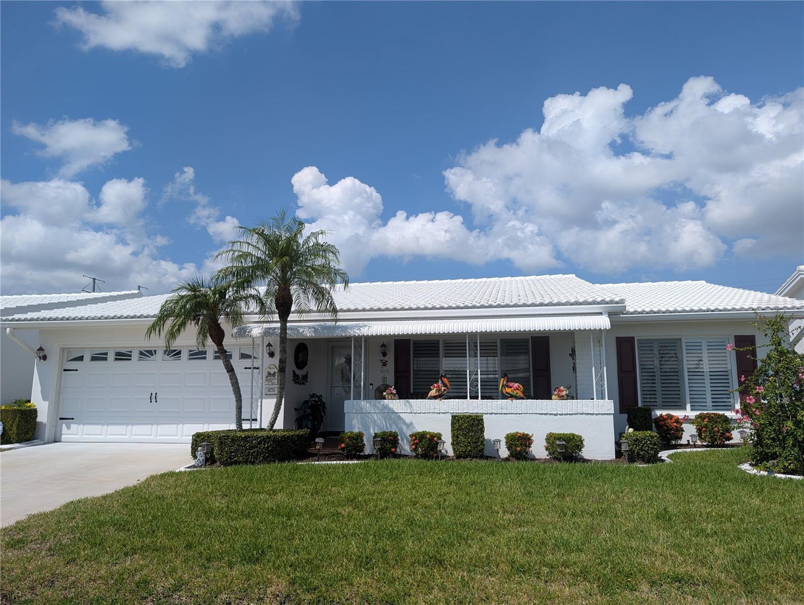 Attention Golfers, Sunseekers, Snowbirds...perfect opportunity to own a fantastic home on Florida's Gulf Coast. Located close to Mainlands Unit 6 clubhouse & pool, this well maintained 2BR/2BA/2CG "Gormay" showcases Pride of Ownership. A coastal flair showcases the exterior. The covered front porch provides a relaxing space to enjoy the Florida lifestyle. Main entry into living room features a stunning hardwood landing. The open concept living area includes the Living, Dining & Florida rooms all surrounding the "Heart of the Home"...the kitchen. Bedrooms & baths are located in hallway accessed from living room. Interior features in living area include warm autumn décor, rich wood flooring and neutral carpeting, ceiling fans and updated light fixtures. The eat-in kitchen features large pantry area, stunning granite countertop, white cabinetry, white double sink satin with tall nickel faucet w/pulldown sprayer, white appliances (Whirlpool refrigerator/glass cooktop range, GE microwave hood/dishwasher), inset ceiling with amazing uplighting, ceiling fan and tile floor. Eat in dining area has direct access to laundry area, located in the garage, which offers a Whirlpool Washer/Dryer set. The Florida room has a wall of windows providing great natural light as well as an awesome view of the backyard, ceiling fan & pass thru window to kitchen...great for entertaining. Dining room connects living room, Florida room & Kitchen. Spacious Primary & Guest bedrooms each have large walk-in closets, ceiling fans, large windows & carpeting. Both bathrooms feature raised vanities with solid surface countertops, satin white vanities, tile flooring, light bars, newer commodes, vents, mirrored medicine chests & satin nickel faucets/shower heads. Primary ensuite bath offers a white walk-in shower w/glass doors & handheld shower heads. Guest bath has a white bathtub w/shower, white tile tub surround. Exterior features include a new cement driveway, covered front porch, gutters/downspouts, updated windows, French drain & tile roof (2003). In addition to the laundry area, the Garage features keyless entry, updated GE Electrical Panel, Carrier HVAC system (2015), State water heater, pull-down stairs, Chamberlain garage door motor (2025), work bench, extra storage cabinets & exterior side door. Unit 6 welcomes 2 pets! Monthly maintenance fee of $395 includes lawn care/irrigation maintenance, exterior painting/power washing, water/sewer/trash, internet/cable in addition to maintaining all community property (clubhouse, pool, roads, sidewalks, lakes)! Mainlands Unit #6 is in an active, 55+ community offering a clubhouse, heated in-ground pool, shuffleboard courts, public golf course & many other activities. A Tropical Paradise located in the "Heart of Tampa Bay" centrally situated between St. Petersburg, Clearwater & Tampa. Additional conveniences include nearby shopping, sporting/cultural venues, excellent medical/emergency care facilities, restaurants, banking, churches and easy access to beautiful Gulf coast beaches, interstate & two airports.