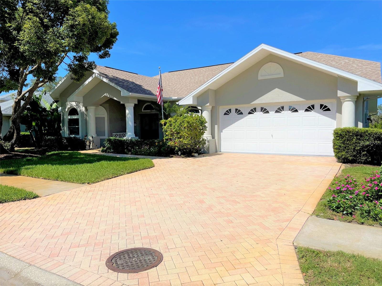 One or more photo(s) has been virtually staged. What are you waiting for? Get more for your money in Hudson while enjoying less traffic! Meticulous owners have made this home extra special! ROOF 2020 which includes additional ridge venting, gutters, $36,900 worth of Durashield energy-efficient, high impact, HURRICANE-RATED WINDOWS with life-time transferable warranty, lovely neutral tile floor in Florida room, exterior paint and plantation shutters in the dinette. Kitchen has newer, PREMIUM STAINLESS STEEL APPLIANCES: LG InstaView refrigerator with door-in-door and double ice-maker, super-quiet Bosch dishwasher with InfoLight that shines on the floor to let you know it is running, LG convection range and LG microwave with hide-a-way vent fan. Guest bathroom has a newer American Standard WALK-IN TUB with ALL THE BELLS AND WHISTLES including SHOWER FEATURE ($14,600 value). Owner bath has a jetted tub AND A SEPARATE SHOWER. Double vanities. His and hers walk-in closets. Florida room overlooks a lovely patio. NO REAR NEIGHBORS with greenspace beyond that will remain greenspace buffer. Garage has a hurricane-rated door, a newer opener and epoxy-finished floor. Lovely curb appeal. Welcoming covered front patio. Pavered driveway. SPARKLING COMMUNITY POOL, right around the corner - no need to have the expense and maintenance of a backyard pool. ROOM FOR A POOL, if a pool is on your wish list. Active community clubhouse. The HOA fee includes lawn care, pest control, high speed wi-fi, cable and twice-weekly trash pickup plus once-a-week recycling!