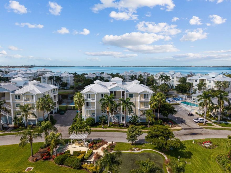 Experience stylish comfort and effortless living in this spacious 2-bedroom, 2-bath condo at Palma Sola Bay Club, a resort-style gated community just a short drive (10–15 minutes) to Anna Maria Island’s pristine beaches, including Bradenton Beach, Coquina Beach, and Holmes Beach, as well as Robinson Preserve. Every detail reflects Florida’s relaxed, elegant lifestyle. Built in 2016, this beautifully furnished 1,650 sq. ft. residence offers a bright, open layout with a large living and dining area filled with natural light, a chef-ready kitchen, and a stunning terrace overlooking the lake, perfect for entertaining or enjoying serene sunsets. The primary suite features a spa-like bath and a generous walk-in closet, while the second bedroom works beautifully for guests, family, or a home office. With in-unit laundry, abundant storage, with approximately $15,000 in carefully selected furniture included, this home is completely move-in ready, ideal as a full-time residence or a great investment property. Residents of Palma Sola Bay Club enjoy true resort-style living with a heated pool and fire pit, fitness center, clubhouse, gas grilling areas, kayak launch, putting green, bocce court, observation deck, and dog park. The beautifully landscaped grounds feature two serene lakes and breathtaking views of Palma Sola Bay. Regular community gatherings, from casual barbecues to holiday celebrations, create a warm and welcoming atmosphere. The HOA fee ($1,060) provides exceptional value, covering cable TV, high-speed internet, water, sewer, trash, recycling, exterior maintenance, flood and fire insurance, professional landscaping, and full access to all community amenities. Few communities offer this much, providing truly worry-free and maintenance-free living. Two assigned garage spaces are conveniently located next to the elevator. A full-time on-site Community Association Manager and Maintenance Manager ensure everything runs smoothly year-round. Perfectly located near amazing beaches, shopping, waterfront dining, and outdoor recreation, this residence combines stylish design, a prime location, and effortless coastal living. Live where every day feels like a vacation, your piece of paradise awaits at Palma Sola Bay Club.