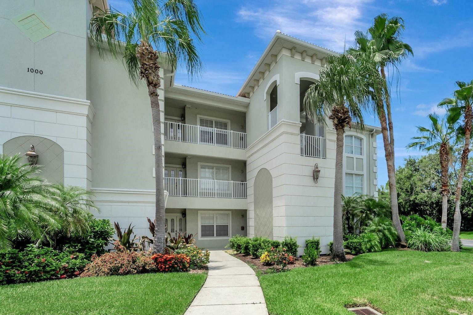 RARELY-AVAILABLE, ONE-OWNER 'PENTHOUSE' UNIT. Enjoy beautiful lake views from your new home among the treetops. This former builder's model has only been occupied since 2011 and has all the extras they offered. Elegant, ceramic tile floors are in all the 'Wet' and living areas, complimenting the generous use of crown molding and tray ceilings. These spacious residences feature 2 bedrooms and 2 bathrooms, a Den/Office 'Flex' room, an En-Suite laundry, a bonus storage room, and a covered and screened-in Lanai. A one-car garage right out front adds to the many perks of San Lino living!