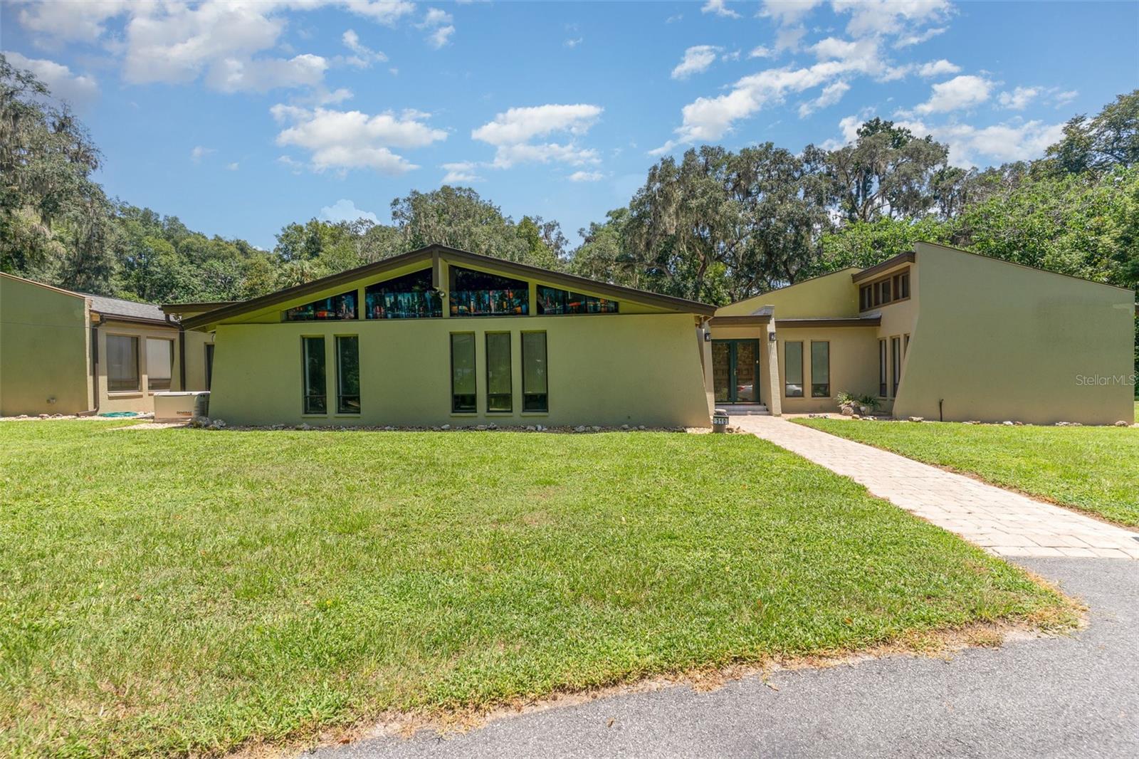 Luxury, Privacy & Versatility on 2.59 Acres in Ocala’s Sherwood Hills
Welcome to 310 SW 35th Street — a private, park-like retreat surrounded by majestic oak, hickory, and pine trees, offering timeless beauty and year-round shade. This impressive estate features a 4-bedroom, 3.5-bath main home plus a garage apartment with private entrance and full bath, perfect for multi-generational living or guest accommodations.
Step inside and discover a home designed for both comfort and style. The spacious family room and dining room showcase stunning tongue-and-groove cathedral ceilings, creating a warm, inviting atmosphere. Walls of glass open to serene views of the sparkling pool and paver patio, flooding the living areas with natural light. The gourmet kitchen boasts a large center island, granite countertops, breakfast bar, dual pantries, and both casual and formal dining spaces—perfect for gatherings big or small. The split floor plan includes a luxurious primary suite with spa-style bath, two guest bedrooms connected by a Jack-and-Jill bath, and a fourth bedroom with its own ensuite.
The garage apartment is a fully self-contained living space with its own entrance—ideal for extended family, visiting friends, or even potential rental income.
Outdoors, the in-ground pool is your private oasis, surrounded by a fenced patio for relaxation and entertaining. The 2.59-acre property offers plenty of open space, with mature trees providing shade, privacy, and a connection to nature. A whole-house generator ensures uninterrupted comfort and peace of mind, and there’s no HOA to limit your vision for the property.
Additional highlights include a two-car garage, well and septic system, updated roof and exterior paint (2021), HVAC (2020), and select interior updates in recent years.
Perfectly located just minutes from downtown Ocala and the World Equestrian Center, this estate blends luxury, practicality, and natural beauty in one remarkable package. Whether you’re relaxing by the pool, hosting guests, or enjoying the shaded grounds, this home is designed for the lifestyle you deserve.
Schedule your private tour today and experience the perfect balance of elegance, comfort, and nature.