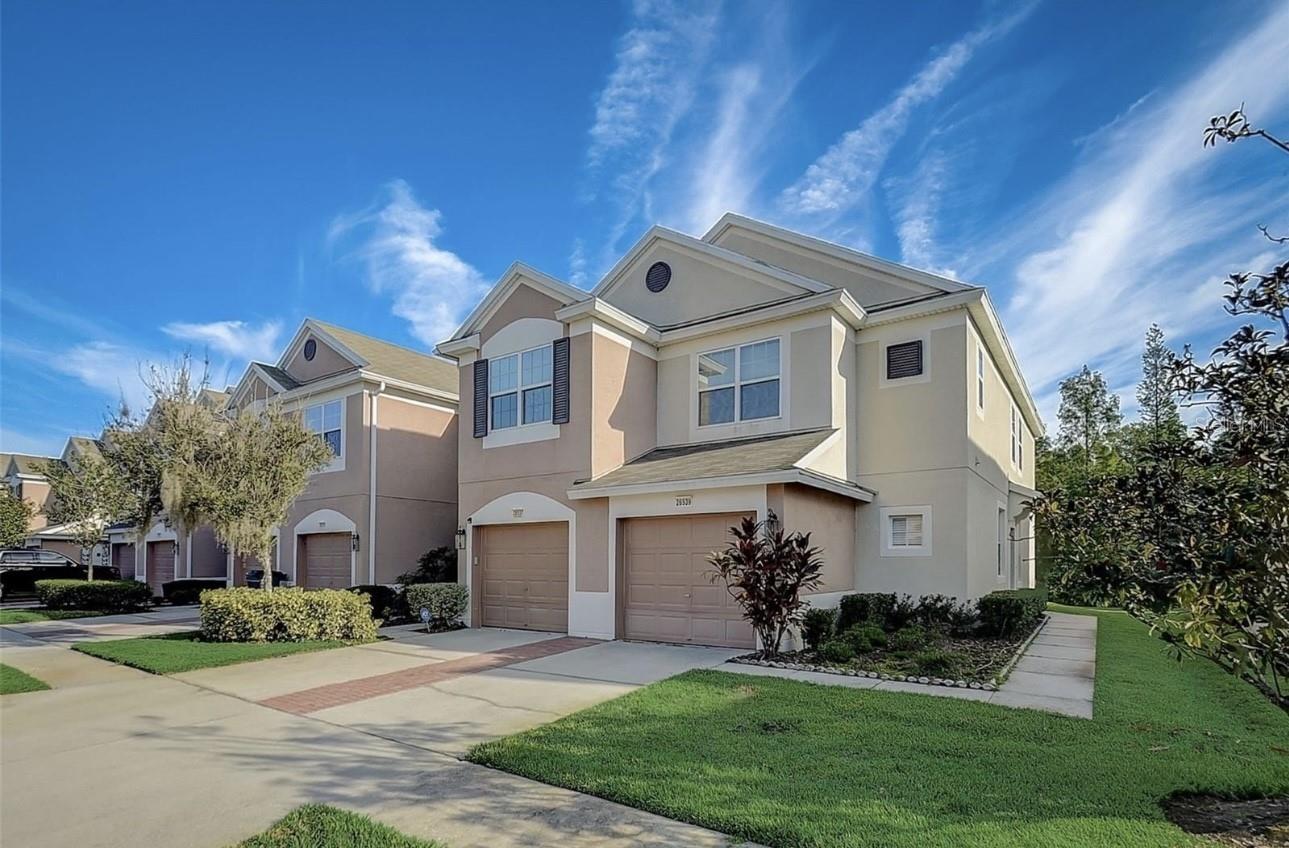 Welcome to 26539 Castleview Way, a exceptional and spacious 3 Bedroom 2.5 Bathroom home sitting in the highly sought-after gated community of Wesley Chapel. Here is your opportunity to rent a private end unit townhome in a great location! Close to I-75, the outlet malls and restaurants, yet tucked away from the hustle and bustle. Located in a smaller gated community with community pool, this newly-painted home has no backyard neighbors, just a serene, quiet view. Stepping inside the home you will appreciate all the natural light, the brand new, large open luxury vinyl plank flooring with the kitchen overlooking the dining and living areas and the access to the covered and screened lanai. The kitchen boasts stainless steel appliances including a side by side refrigerator, real wood cabinets and a large pantry for storage. Near the garage entrance is a half bath for guests. Upstairs are three generous bedrooms as well as the laundry with washer and dryer. The spacious owner's suite features vaulted ceilings, a private view of the backyard, ceiling fan and large walk-in closet. The attached en-suite bath provides a double vanity for plenty of storage and a garden tub with shower. The front bedroom is roomy and also has valuted ceilings and a private entrance to the second full bathroom. This ideal home will be your best choice to rent (Important: trash pickup and water fee is covered in the rent), so please schedule your private tour of this exceptional home today!