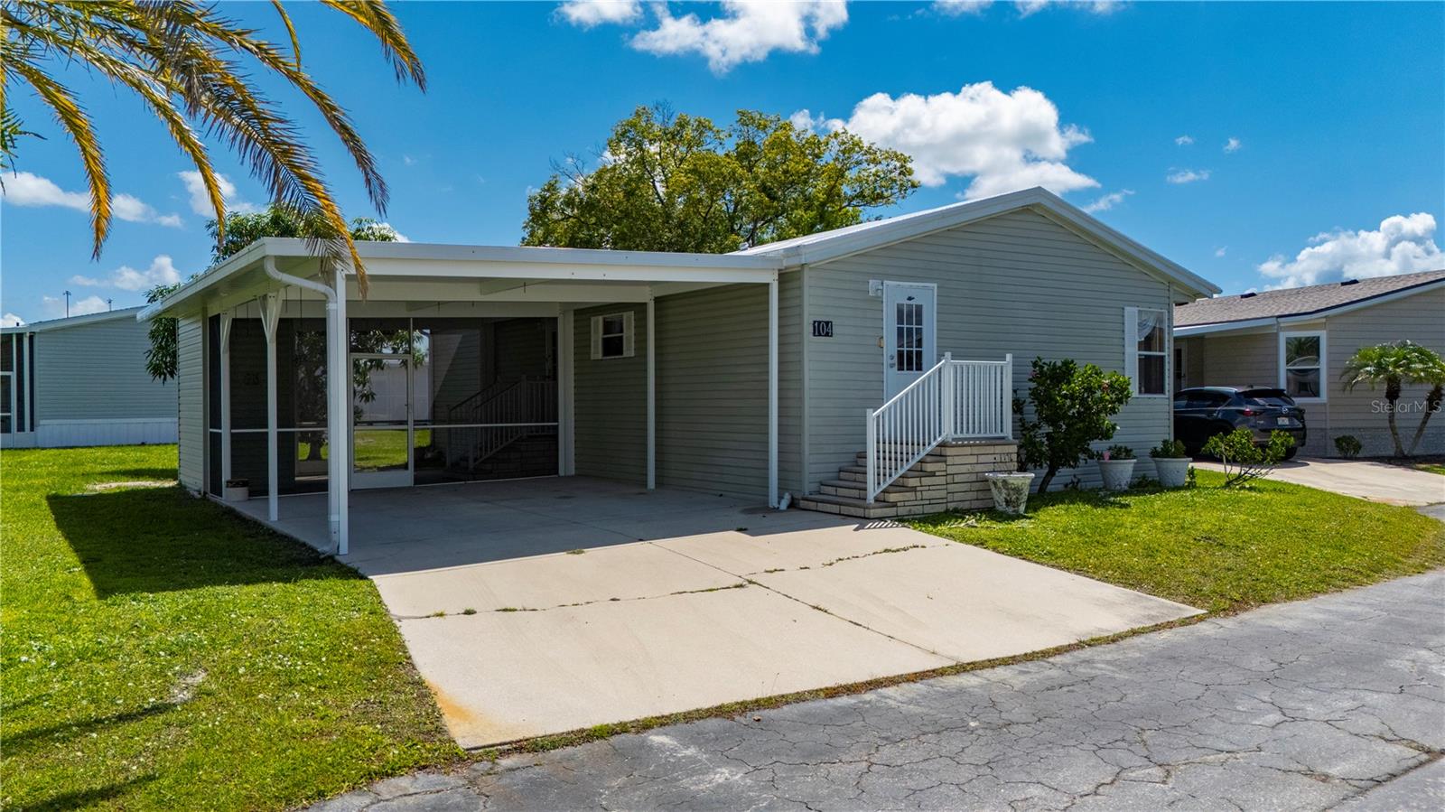** Port Charlotte Village was voted #1 manufactured home community in 2024 in Charlotte County** Welcome to this beautifully updated 2-bedroom, 2-bathroom manufactured home located in a desirable 55+ community. This charming residence features an oversized driveway and a large screened-in lanai with an attached storage shed—perfect for enjoying Florida’s outdoor lifestyle. Inside, you’ll find brand-new luxury vinyl flooring throughout, fresh interior paint, and a spacious, open layout. The kitchen is a standout with a generous island, an abundance of solid wood cabinetry, and plenty of counter space, making it ideal for cooking and entertaining. Adjacent to the kitchen, the dining room showcases a lovely built-in hutch, while the expansive living room offers plenty of space to relax and unwind. Both bedrooms are oversized and include large walk-in closets, and the primary bathroom is generously sized with a large linen closet. A new roof was installed in 2023 for added peace of mind.
This vibrant 55+ community is conveniently located close to shopping, entertainment, elite golf courses, a wide variety of restaurants, and the stunning blue waters of Florida’s Gulf Coast beaches. Don’t miss the opportunity to enjoy comfort, convenience, and coastal living all in one place! Port Charlotte Village is NOT in a flood zone