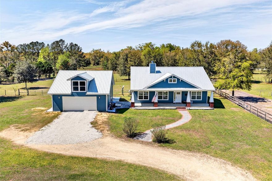 Welcome to peaceful country living in the heart of Newberry, Florida. Situated on 5.09 fully fenced acres, this beautiful farm offers the perfect balance of comfort, functionality, and open space. Ideal for horse owners or those seeking a private country setting without sacrificing convenience, the property also includes a detached 1-bedroom, 1-bathroom in-law suite with an attached climate-controlled 2-car garage—perfect for guests, extended family, or potential income.

The 3-bedroom, 2-bathroom main home features 1,584 square feet with a thoughtfully designed split floor plan that provides both privacy and an open, fluid living space. The spacious primary suite offers a large bedroom, generous closet with attic access, and an ensuite bathroom complete with a walk-in shower and relaxing soaking tub.

The main living area is warm and inviting with a wood-burning fireplace, creating the perfect place to unwind after a day outside. The beautifully appointed kitchen includes all appliances, with the refrigerator being only two years old. The washer and dryer are included for added convenience. Two additional bedrooms are located on the opposite side of the home, making the layout ideal for family or guests.

Step outside to the screened-in back porch, where you can enjoy Florida evenings protected from the elements, or gather around the fire pit while taking in stunning west-facing sunset views across your property.

Designed with equestrians in mind, the farm features a 3-stall barn with wash rack, along with a lockable tack room and feed room. The property includes four main pastures, two run-in shelters, and ample space to add an arena or additional paddocks, offering flexibility for a variety of horse operations.

A beautiful in-law suite built just over a year ago provides additional living space and income potential. The 312 sq ft guest residence includes 1 bedroom and 1 bathroom with beautiful finishes throughout and an attached climate-controlled 2-car garage. All construction was fully permitted and completed to code.

The property has been meticulously maintained, including fresh exterior paint completed in 2025 and “forever screws” installed in the roof in 2025 for long-term durability. Both homes are bonded for termite and pest protection, offering additional peace of mind.

Despite its peaceful country setting, the property offers exceptional convenience. Located less than 5 miles from Publix, Bravo Supermarkets, multiple restaurants, Ace Hardware, coffee shops, boutiques, and a fitness center, you can enjoy the charm and quiet of small-town living without sacrificing everyday amenities. Additionally, there are plans for a Wawa and shopping center coming later this year, just minutes away on SR 26. The farm is also ideally positioned less than 40 minutes from Gainesville and approximately one hour from Ocala, making it easy to access larger city conveniences while still enjoying the privacy and tranquility of your own acreage.

With peace, privacy, and breathtaking views overlooking your horses, this property captures the true essence of North Florida farm living while offering the convenience of nearby town amenities.