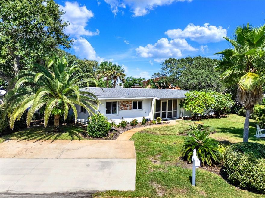 Beachside mid-century retreat with SALTWATER POOL just 3 short BLOCKS from FLAGLER Avenue! *** NO FLOODING - flood insurance is NOT required for this property! *** Step into timeless style and coastal comfort with this beautifully designed 3-bedroom, 2-bath MID-CENTURY inspired home, just steps from the sands of New Smyrna Beach. Situated on an oversized CORNER lot (.21 of an acre) with a FENCED backyard, this beachside retreat blends modern updates with classic charm, offering the perfect balance of relaxation and convenience. Inside, the open concept living space is filled with natural light, PLANTATION SHUTTERS, restored TERRAZZO floors, custom doors with glass knobs, a stunning accent wall in the dining area, and a wood burning fireplace with storage for the firewood. The primary suite is located on the opposite side of the home away from the spare bedrooms, and features two closets with sliding doors, a linen closet for added storage, and a vintage styled bath. The two additional bedrooms include spacious closets and multiple windows, drawing in the outdoors. The kitchen overlooks the front yard and patio, and is enhanced with QUARTZ counters, a refrigerator (2021), oven, cooktop, and BOSCH dishwasher (2021). Enjoy panoramic views of your private oasis from the main living area of the home. A sparkling saltwater HEATED POOL (added in 2023) with TRAVERTINE decking is surrounded by tropical landscape, outdoor lighting, and generous lounge areas—perfect for entertaining or soaking up the Florida sunshine. The area is also enhanced with top-of-the-line TRUE appliances, including an ice machine, kegerator, and mini-fridge. When you arrive home from the beach, enjoy showering off in your very own OUTDOOR SHOWER, then head to the pool for a dip! A screened-in front porch welcomes you as you enter the home, giving you endless opportunities to entertain on either side of the house. The oversized garage (~21 X 22 + storage closets) provides ample space for a vehicle, golf cart and beach gear, and includes storage closets, making everyday living easy and functional. The laundry room (~9 X 11) is adjacent to the garage and includes additional closet space. If you’re looking to EXPAND the living area, the garage would be the perfect place to renovate given the size of the yard and various places to park. UPDATES: backyard oasis with pool and True appliances (2023), AC (2020), small flat roof (2024), shingle roof (2017), electrical (2017), custom doors, irrigation, landscape lighting in the front and back yard, outdoor shower decking. Additional features: whole house HURRICANE SHUTTERS, concrete BLOCK home, brick accent wall. With its prime location, you’ll enjoy easy access to New Smyrna’s vibrant shopping, dining, and entertainment scene, all just minutes away (Flagler Avenue: ~ 3-minute walk * BEACH: ~ 8-minute walk * The Garlic/Norwoods: ~ 12-minute walk). Cruise on your GOLF CART or stroll the streets, NSB is the place to be! Nearby, you can enjoy climbing the Ponce Inlet Lighthouse, playing at the dog beach, strolling the non-driving section of the beach, or exploring the Canaveral National Seashore. Whether you’re seeking a full-time residence, vacation getaway, or investment property, this home offers the best of Florida living in a coveted beachside setting. Schedule a showing today and make this MID-CENTURY retreat your own!