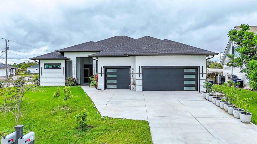 4,105 SQFT total 2714 under air. Welcome to this spectacular, centrally located home nestled on a large corner lot. Situated just minutes away from schools, hospitals, shopping, and entertainment, this gorgeous, move-in-ready property offers the perfect blend of luxury, space, and convenience. No expense has been spared in creating this remarkable 4-bedroom + den, 4-bathroom home, providing an unparalleled living experience. From the moment you approach the front of the house, you'll be captivated by the manicured lawn and impressive impact French doors that stand 8 feet high and 6 feet wide. Step inside to find a cavernous living area filled with an abundance of natural light, thanks to impact windows throughout the home. High 10-foot tray ceilings add to the spacious, airy atmosphere. The home features stunning imported porcelain 24” x 48” tile floors, offering both beauty and durability. The chef-inspired kitchen is truly a dream, showcasing an oversized island with exquisite quartz countertops and a waterfall edge, paired with a quartz backsplash for a seamless design. Equipped with top-of-the-line stainless steel KitchenAid appliances, including double wall ovens, a French door refrigerator with drawers and an ice maker, and a generous pantry, this kitchen will inspire your culinary creativity. The exquisite lighting throughout enhances the home's refined aesthetic. The humongous master bedroom is a sanctuary, complete with a walk-in closet for him and her, offering an abundance of storage. The master bathroom is equally luxurious, with double sinks and matching quartz counters, complemented by backlit, changing-color mirrors that include a defogging feature. A jetted tub provides the perfect spot for relaxation, and the family-sized shower features multiple shower heads for a spa-like experience. Need extra space? The huge den with two windows is perfect for a home office, hobby room, playroom, or even a 5th bedroom. The laundry room is equipped with front-loading washer and dryer, cabinets, and a sink for added convenience. Very fancy out door kitchen already done, including brand name grill and electric stove and fan hood ideal for entertaining friends and family. The triple-car garage includes electric door openers and is finished with epoxy floors with metallic flakes for durability and style. This home is built on a stem wall foundation, ensuring no cracks and guaranteeing lasting quality. Second driveway to park your RV or BOAT. Over 10 popular varieties mango trees, longan tree, star apple tree, avocado tree, seedless guava tree, banana treasured wax jumbo tree planted. The house is fully furnished with new furniture, the furniture is priced separately. This unique gem offers everything you’ve been looking for in a home—luxury, space, and a prime location. It’s easy to show and will not last long! Don't miss out—schedule a tour today! PS Flood Zone X. No Flood Insurance required by a lender.