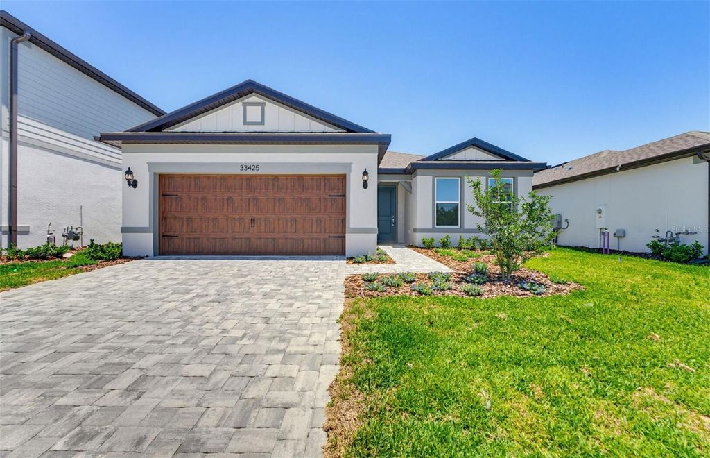 Photo of 33425 Herds Hallow Way, Wesley Chapel, FL 33545 (MLS # TB8469642)
