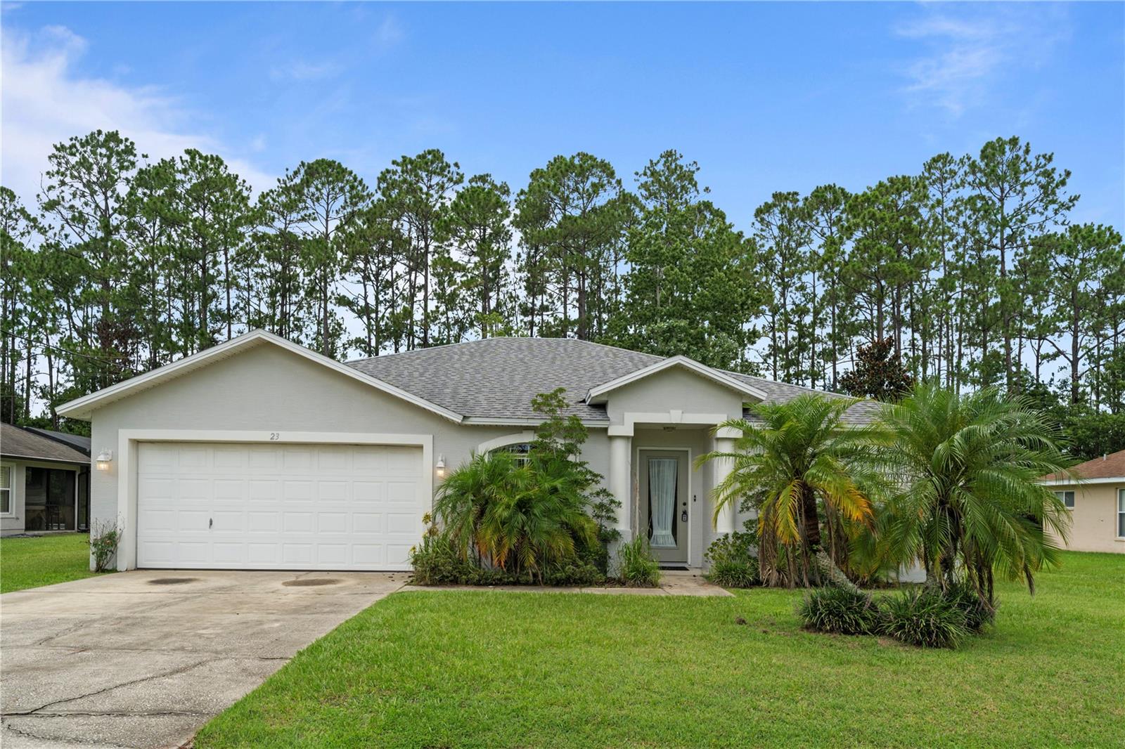 Welcome to this well-maintained 3-bedroom, 2-bathroom concrete-built home nestled in the heart of Palm Coast on Woodside Drive. Offering 1,641 square feet of comfortable living space, this thoughtfully designed split floor plan ensures both privacy and functionality. As you enter, you’re greeted by a formal living room and dedicated dining area—perfect for hosting gatherings or enjoying quiet evenings at home. The kitchen sits at the heart of the home, complete with a convenient breakfast bar and open sightlines to the spacious family room, creating an ideal space for everyday living and entertaining. The primary suite is generously sized and features a private bathroom with a garden tub, separate walk-in shower, and dual vanities for added convenience. Two additional bedrooms and a full guest bath complete the layout, making this home suitable for families or guests. Sliding glass doors from the family room lead to a covered patio, ideal for outdoor dining or relaxation. A laundry room is conveniently located just off the kitchen and provides direct access to the attached 2-car garage. The home features a mix of tile and carpet throughout, combining comfort and style. Located in a peaceful Palm Coast neighborhood with no HOA, this home offers easy access to local parks, schools, shopping, and the beautiful beaches of Flagler County. Whether you're looking for a primary residence, vacation home, or investment opportunity, this property presents excellent value in a sought-after location. Enjoy!