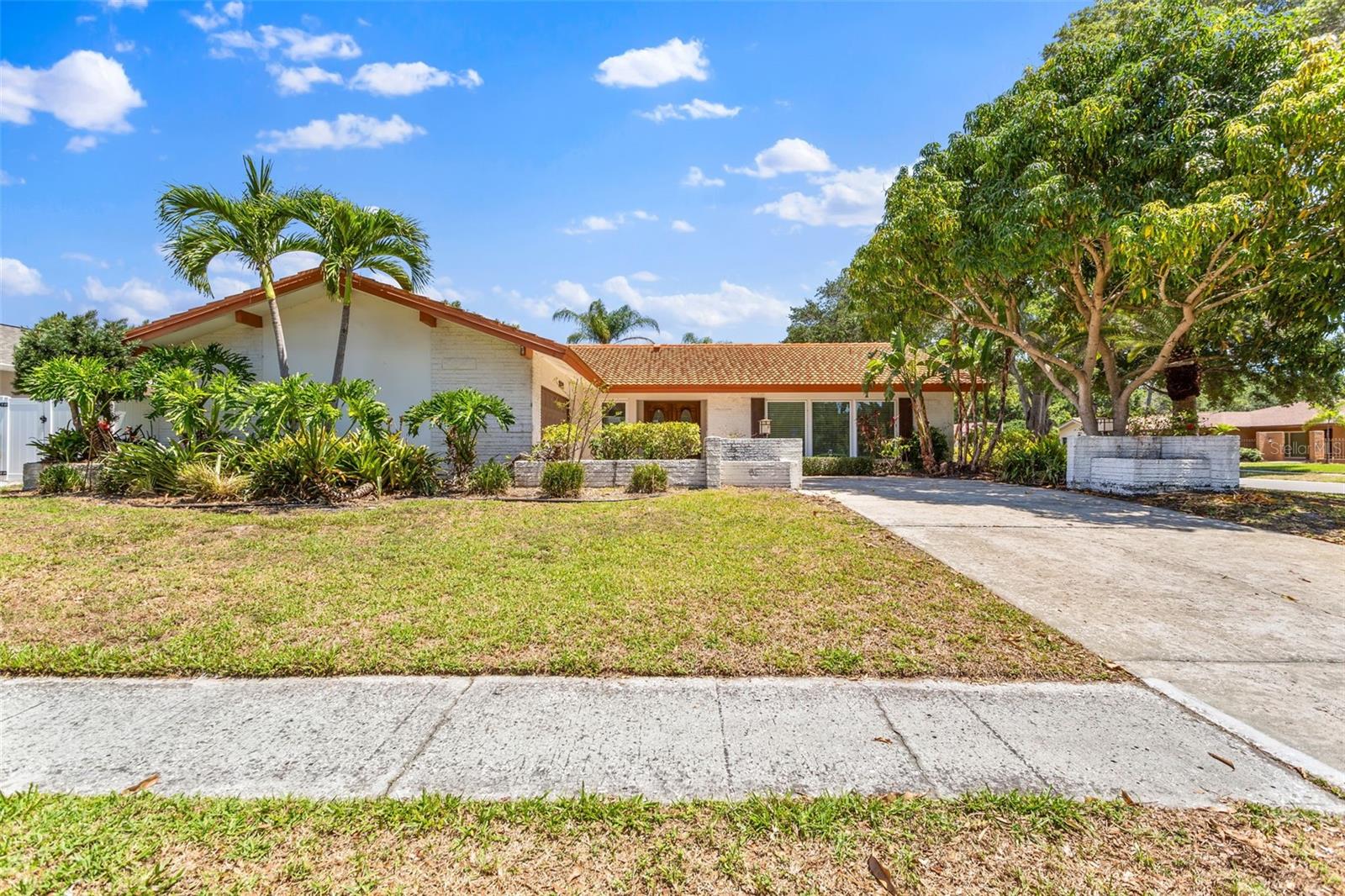 Currently occupied, do not disturb tenants. Showings by appointment only. Welcome to this meticulously maintained 4-bedroom, 3-bathroom pool residence located in the highly sought-after Countryside neighborhood. Positioned on a prime corner lot, this home features an oversized two-car garage and an expansive pool. Recently updated, the home includes luxury vinyl flooring, ceiling fans throughout, a modern kitchen, floor to ceiling brick fireplace, a whole home water softener, and more. The kitchen, equipped with stainless steel appliances and quartz countertops, offers a delightful view of the pool. The family room's full-length sliders can be fully retracted, creating a seamless transition to the screen-enclosed pool area. Ideal for entertaining, the outdoor space includes a large pool (Maintenace included) with stone pavers, a screened lanai, spacious lawn, and mature landscaping. The interior boasts a desirable split floor plan with two living areas and a dedicated dining space. The primary bedroom, situated on one side of the home, features a large walk-in closet, an additional closet, an en suite bathroom with large vanity, and an enclosed shower. The guest bedrooms are positioned on the opposite side, with two sharing a Jack 'n' Jill bathroom and the fourth bedroom enjoying access to a well-sized full hall bathroom. Additionally, there is a spacious laundry room with ample storage. Conveniently located just minutes from Countryside Mall, Phillipe Park, Downtown Safety Harbor, top-rated beaches, shopping centers, and renowned restaurants, this home offers the perfect blend of comfort and convenience. Pets are allowed, and the home is available starting July 3rd. Contact us today to schedule a viewing this property won't last long! Pool maintenance included, tenant responsible for all utilities.