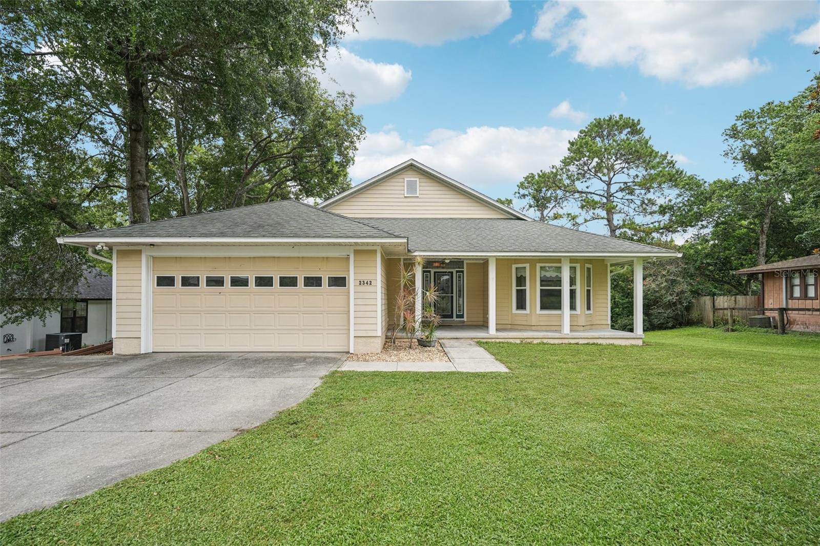 Custom 4-Bed, 2-Bath Home with Water Views – No HOA! Located on a quiet dead-end street just minutes from downtown Mount Dora, this one-owner home offers peaceful living with stunning water views of Wolf Branch Creek from both the main deck and walkout basement. Inside, enjoy a bright open layout with 10’ ceilings, crown molding, and hardwood flooring in the great room. The kitchen features 42” upper cabinets, Corian countertops, pantry with auto-light. French doors lead to the front bedroom, while the spacious Master Suite with Creek views, private deck access, and two walk-in closets. The large unfinished walkout basement with 2 French doors and a full bath offers endless potential—perfect for a guest suite or rec space. The synthetic deck, Hardi siding, and 35-year architectural shingles ensure low maintenance living. Additional highlights: new carpet, new paint, alarm system, 9' insulated garage with attic storage, built-in window seat, and custom finishes throughout. No HOA, energy-efficient, and full of charm—this home combines comfort, quality, and location in one beautiful package. Don’t miss the chance to own this unique creekside retreat!