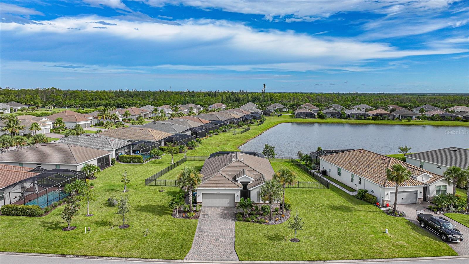 BEST VALUE IN HARBOR WEST! Enjoy the largest interior lot in the community that is completely FENCED and has a HUGE BACKYARD. This 4-bedroom, 3-bathroom home boasts a HEATED POOL & SPA, an EXTENDED LANAI and an already large patio that is perfect for relaxing and enjoying the serene LAKE-VIEW while sitting by the pool. The home is fitted with IMPACT WINDOWS AND SLIDERS that grant FULL HURRICANE PROTECTION but also give you the benefit of never having to worry about putting up or taking down any hurricane shutters. Enjoy the convenience of a TILE ROOF that typically last much longer than a standard shingle roof and gives the home a Mediterranean style look. Inside you'll find a spacious open-floor plan with a split bedroom layout outfitted with 12x24 throughout the home and beautiful granite countertops across all of the countertops in both the kitchen and bathrooms. The charming upgraded white kitchen features a large island for an informal dining space, a large pantry, and stainless-steel appliances. The primary bedroom is ample in space and comes with two big-walk in closets. The primary bathroom comes complete with his and her sinks and a large shower with a Kohler Artifacts Hydro rail system with a rain head attachment or a handheld attachment for your showering pleasure. The 2nd bedroom is also very spacious and is positioned in a private part of the home away from the other bedrooms and comes with its very own on-suite bathroom. The front wing of the home comes with two more well-sized bedrooms that can be used for a variety of things besides just a bedroom, maybe a den, office, workout room, etc. The front wing comes with its own convenient bathroom. Great for guests or for quick use. The large laundry room is located just off the 2-car garage and is outfitted with 42' soft close cabinets. Underrated features include charming plantation shutters on the interior of all the windows, elegant lighting and upscale fans, Koehler faucets in master bathroom and matching towel and toiletry bars in all baths. The brick paver patio has been maintained and resealed to increase its longevity. The paver driveway is large and wraps around to the air handler. The home has a nice screened in entryway with decorative front shutters. The whole house has gutters around it. Gray plank tile throughout and a warm light neutral gray interior lends the perfect backdrop for your designer inspirations. This is located in Harbor West which is a GATED COMMUNITY with NO CDD FEES. The lawn Maintenace and irrigation is taken care of by the community. This property is not one that you'll want to miss. BE SURE TO VIEW THE 3D VIRTUAL TOUR ON ZILLOW. Don't forget the close proximity this property has to both Manasota Key Beach and Englewood Beach as well to Restaurants, bars, grocery stores, medical offices. Tampa Rays and Atlanta Braves play Spring Training nearby every year. You won't be disappointed with this located! This home has NEVER FLOODED, and a Survey and Elevation Certificate are available. Call your agent to book your showing today!