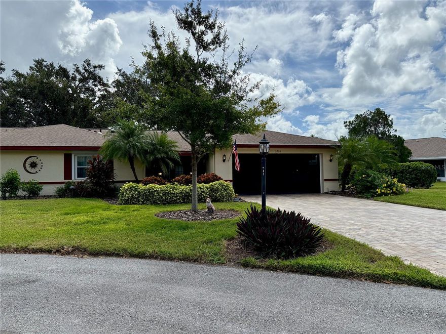 Hurry to visit the BEST CONDO DEAL in Kings Point!  You'll truly have it "made in the shade" in this gorgeous condo tucked away on a quiet, tree-lined street.  This bright and airy home features a spacious updated kitchen with sleek steel-gray appliances, a pantry, and an eat-in area that opens to the versatile Florida room--perfect for relaxing or creating a hobby space.  Vaulted ceilings, newer windows, and a stylish front door enhances the home's charm, while extras like a Culligan water softener with reverse osmosis, ample storage, and pull-down hurricane shutters add everyday convenience and peace of mind.  The main bathroom offers an elevated granite countertop and a walk-in jetted tub/shower for comfort; and keep in mind that the water (both inside and out) is included in the monthly HOA fee.  Both bedrooms include two closets each.  The home boasts of "tons of closet space" throughout.   Natural light pours in through three skylights, and the inside laundry room (with washer and dryer) leads directly into the two-car garage with abundant storage, a newer hurricane-rated door with keypad, and an extended driveway.  Additional upgrades include a replaced electrical panel with surge protection, a nearly new roof, and a newer AC system.  Step outside to your lush backyard with a brick patio--ideal for grilling, entertaining, or simply relax and enjoy the trees, flora, and plant life; or if you prefer, enjoy the front enclosed porch while visiting with neighbors!   Condo fees cover yard care, irrigation, water, exterior building maintenance (including roof and painting), pest control, basic cable, and access to endless community perks: arts and crafts, tennis, pickle ball, several pools, two fitness centers, a variety of clubs, restaurant/bar and more.  Best of all, you'll be just miles from Tampa Bay, sporting events, theme parks, and several international airports and cruise terminals.  Move into this golf-cart friendly community and get ready to "live the life."