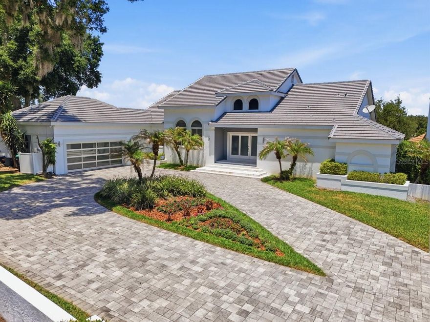 ENJOY BAY HILL GOLF COURSE LIVING AT ITS FINEST! Welcome to the neighborhood’s best-kept secret. This magnificently updated, modern-design home is stunning from every angle and sits on an oversized flag lot—set well back from the street at the end of a quiet cul-de-sac in South Bay—offering exceptional privacy and tranquility. NEW ROOF IN 2025, adding peace of mind and value to this already impressive property. Built by custom builder Ray Coudriet, this home boasts 212 feet of golf course frontage with unrivaled views of the 16th and 17th holes of the Bay Hill Golf Course from both levels, indoors and out. The terraced rear elevation offers the ultimate vantage point to enjoy the famed Arnold Palmer Invitational golf tournament right from your own backyard. This 6-bedroom, 5-bath residence has been completely renovated with top-of-the-line luxury finishes and mechanical upgrades throughout. Whether you're hosting guests or seeking a peaceful retreat, the thoughtfully designed layout offers both sophistication and comfort. Gleaming marble floors flow through the main living areas, while lighted tray ceilings and expansive picture windows create a bright, elegant atmosphere. The chef’s kitchen is a showstopper—equipped with a Thermador 6-burner 36” range, 42” hood, Sub-Zero wine fridge, and built-in fridge/freezer drawers. It’s perfectly positioned at the heart of the home with ample seating and an inviting ambiance for gatherings. Also on the main level is the luxurious Master Suite, complete with “his and hers” closets, tray ceilings, a generous sitting area with a private balcony, and a spa-style bathroom with soaking tub. A second bedroom on this level doubles perfectly as a home office or study. The home’s unique sloping topography enhances the lower level, which is designed for both relaxation and entertainment. With elevated views of the golf course and seamless access to the pool and outdoor living space, you'll enjoy resort-style living every day. This level includes a wet bar with Uline bar fridge/freezer and GE Profile dishwasher, four spacious bedrooms, and a welcoming lounge area with an indoor/outdoor fireplace. Additional features include a 3-car garage (2-car plus golf cart space) with soaring ceilings—ideal for the car enthusiast with potential for hydraulic lift installation to accommodate four vehicles plus a golf cart. View 3D virtual tour link to experience this amazing property. Don’t miss your opportunity to own this one-of-a-kind luxury estate—schedule your private tour today!