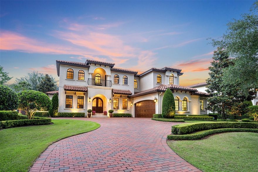 Luxurious and inviting, this custom one-owner home has it all and is on a quiet brick street in the desirable Via’s of Winter Park, elevated on a generous sized lot with views of Lake Knowles. Meticulously cared for, this true five-bedroom split floor plan is well appointed and fantastic for entertaining with oversized interior living spaces that spill onto elegant outdoor covered area with cabana, pool, and lawn. Open concept meets traditional with wide open living and dining spaces, but also with rooms that close off for flex space and privacy. The first floor has private study/music room, and a great room with gas fireplace and built-ins that opens to kitchen, dining, and bonus/sunroom. Kitchen features walk-in pantry, natural gas stove, large kitchen island with storage, soft-close drawers, granite counters, Thermador stainless appliances, double ovens, and eat-in breakfast nook. Adjacent wine room with copper sink. Downstairs owners’ suite has motorized black-out draperies over arched transom windows and luxe bathroom with 2 walk-in closets, double vanities, & separate shower + spa tub. Additional downstairs guest suite. The upstairs houses 3 bedrooms, all with lake views, with one bedroom suite split from the other two which share a bathroom and a Juliet balcony. Features include tall ceilings (11’ down, 9’ up), wood floors, crown molding, French doors, designer window treatments, solid doors, custom closets & lots of storage, and whole house natural gas generator. The exterior feels like a resort with Signature Landscaping and outdoor lighting by Illuminations USA. Private brick-wall surrounds saltwater pool with heated spa and outdoor cabana with summer kitchen & fireplace, large outdoor patio room with motorized retractable screens. Circular natural brick driveway, travertine front porch, rear paver patios and precast features throughout the exterior. Large garage with extra-large storage closets, shelving and work area. Great location close to downtown Winter Park, Kraft Azalea Gardens, and Winter Park Racquet Club.