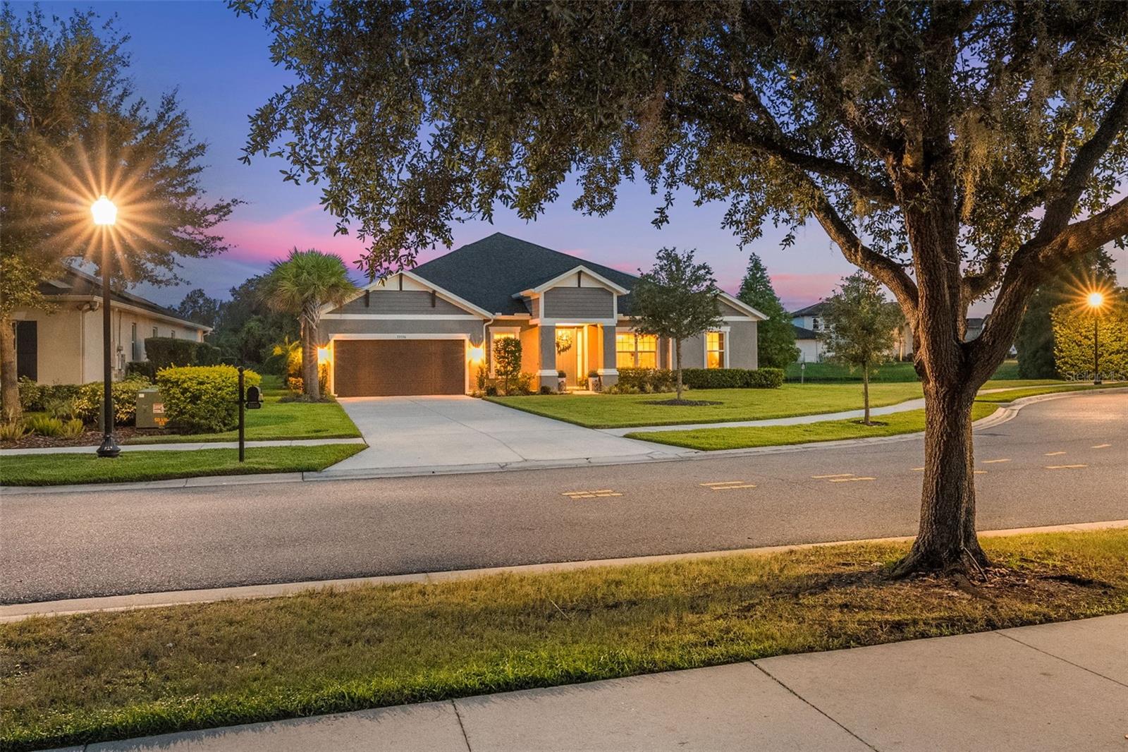 Private Water and Conservation View Oasis with Heated Saltwater Pool in Gated Watergrass. This 4-bedroom, 3.5-bath, 3,200+ sq. ft. home with 1,250 sq. ft. of outdoor living space offers unmatched privacy, designer upgrades, and breathtaking water and conservation views in one of Wesley Chapel’s most exclusive gated enclaves. Key Features: Gourmet kitchen with GE Elite stainless appliances, double oven, walk-in pantry with custom shelving, Butler’s pantry, and coffee bar, Outdoor paradise: heated 11,000-gallon saltwater pool with color-changing magic bowls, therapy jets, sun shelf with bubblers, travertine edging, and screened enclosure with lighting, Media room with direct access to pool area for seamless entertaining, Designer details: luxury vinyl floors, plantation shutters, custom motorized shades, tray ceilings, double crown molding, high-end lighting, and upgraded 5¼” baseboards, Custom storage: built-in closets in primary suite and one secondary bedroom, plus laundry room cabinetry, Smart-home ready: MyQ garage door opener and 85” Samsung Frame TV included, Oversized driveway with space for multiple vehicles, Prime location: 4 miles to I-75, blocks from Publix and Starbucks, 15 min to Tampa Premium Outlets & Wiregrass Mall, 35 min to Downtown Tampa, 45 min to TPA, 75 min to Disney. This home has been meticulously maintained and shows like a professionally designed model. Experience resort-style living with peaceful water and conservation views in Watergrass.