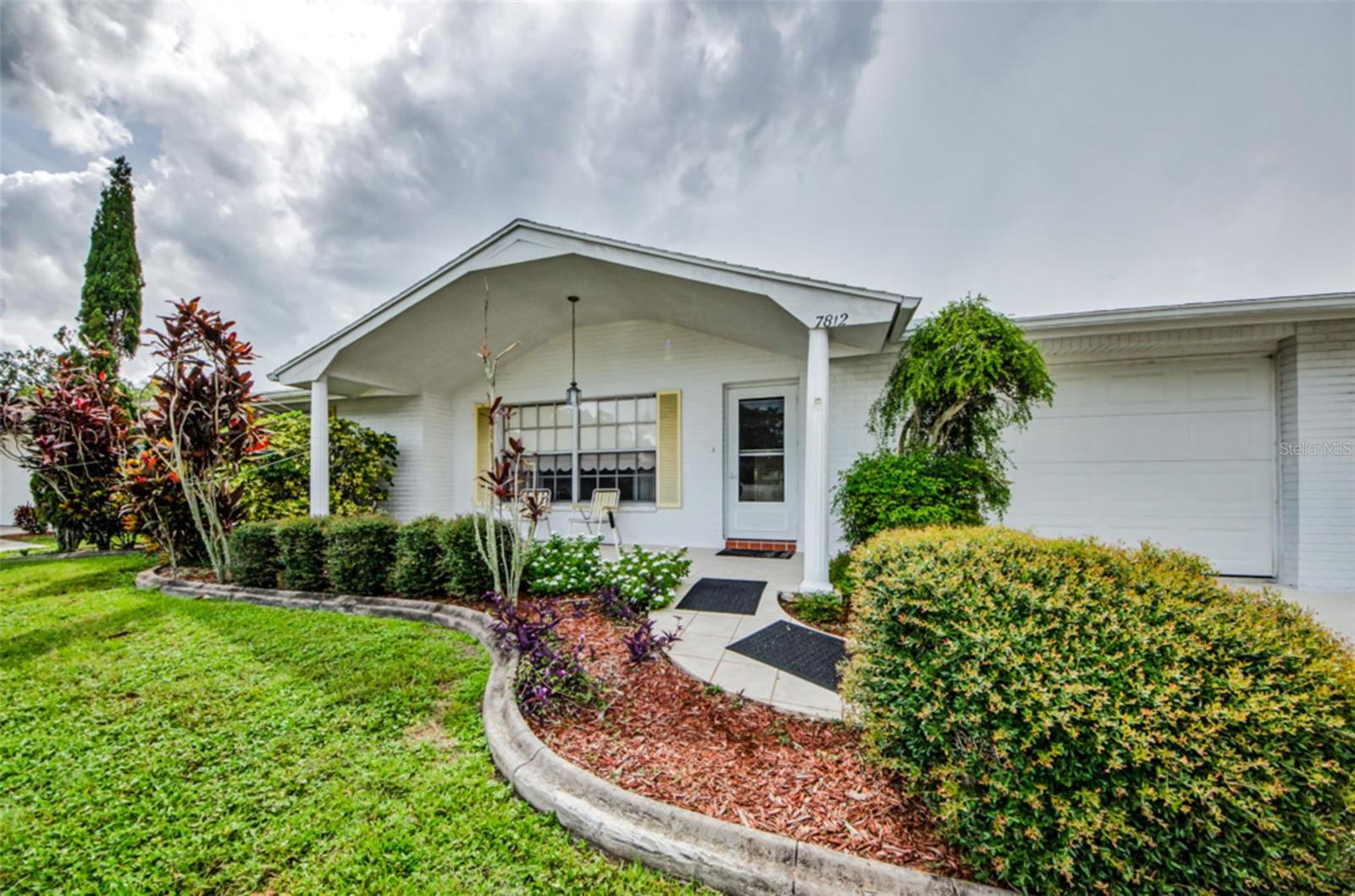 Welcome to your new home on Cherrytree Lane in charming New Port Richey! This beautifully maintained 3-bedroom, 2-bath home offers striking curb appeal and has been lovingly cared for by its original owner. Nestled on a quiet street, the property features a welcoming front porch and a serene backyard--perfect for relaxing or entertaining--with a patio area and beautiful landscaping that provides plenty of privacy. Inside, you'll find a split-bedroom plan with all the space you need for family and friends. There is also a generous Florida room bathed in natural light, ideal for enjoying Florida living year-round. Just minutes from the very popular downtown New Port Richey, that provides endless opportunities to enjoy the nightlife, family entertainment, and many restaurants, festivals and parades. Don't miss this rare opportunity to own a well-loved home in the peaceful, established neighborhood of Magnolia Valley.