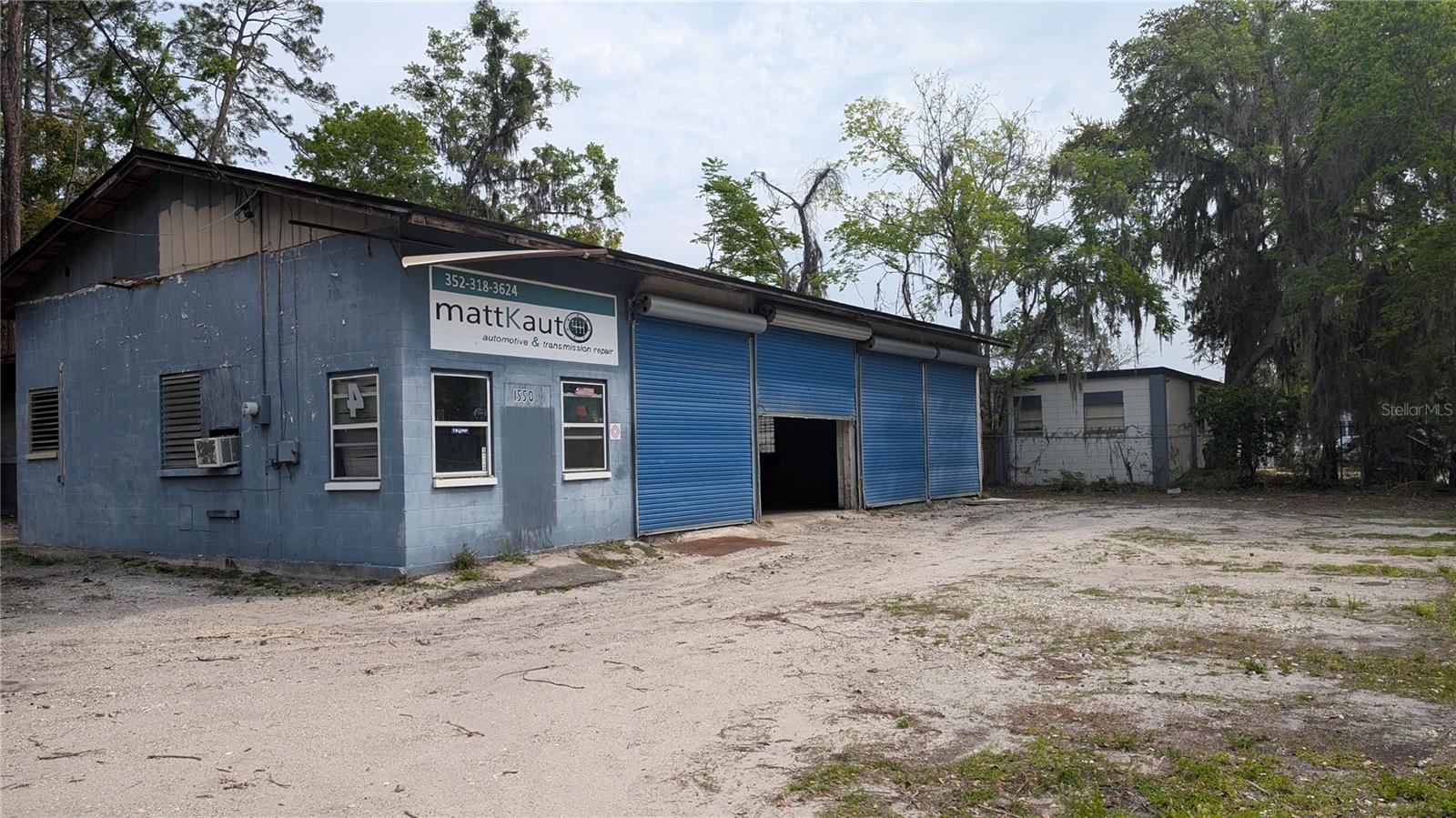 Service shop with four bay doors, two lifts and spray booth.