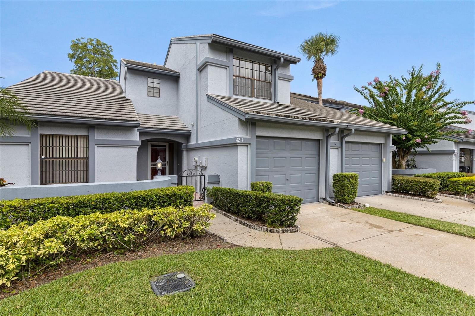 RARE OPPORTUNITY! End-Unit Townhome with First-Floor Primary Suite in Brentwood Park, one of Carrollwood’s most desirable, low-maintenance neighborhoods. This 3-bedroom, 3-bath end-unit home, one of the community's most spacious, offers 1773 SF of living space in a thoughtfully designed layout with comfort and convenience in mind. The primary suite is located on the first floor, featuring a large walk-in closet, dual-sink vanity, and a relaxing jetted garden tub. A second downstairs bedroom is ideal for guests or home office needs, with a full bath featuring a walk-in shower just steps away. The bright, tiled kitchen includes a cheerful breakfast nook, abundant cabinetry, and easy access to the adjacent dining area and enclosed porch—also accessible through sliding doors off the living room and primary suite. Vaulted ceilings soar above the spacious living room, where laminate wood flooring and natural light create a warm and welcoming atmosphere. Enjoy your private courtyard with a wrought iron gate, brick pavers, and a charming lantern light—perfect for morning coffee or evening relaxation. A serene pond view offers a gentle water feature, adding to the tranquil setting. Upstairs, you’ll find a full private wing complete with loft, third bedroom, and full shower/tub bath, all with cozy Berber carpeting—perfect for guests or multigenerational living. A dedicated laundry room with utility sink adds everyday ease, as does a 1-car garage. Brentwood Park is a well-maintained, pet-friendly community with mature landscaping, a community pool, and low HOA fees. Enjoy a prime location, near top-rated schools, shopping, dining, within walking distance to the Northdale Golf & Tennis Club, and easy access to major transportation routes. Come quick!