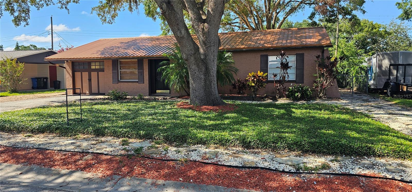 Your Lutz Home Awaits! No HOA, Low Maintenance & Full of Charm! Welcome to your dream home tucked away in the heart of Lutz, Florida! Located on a peaceful, no-outlet street, this lovingly maintained residence offers the perfect blend of serenity, practicality, and convenience.{Peace of Mind & Easy Living}
Owned and cared for by the same family for 22 years, this home features a beautifully xeriscaped yard designed for low-maintenance living. Decorative slate rock, drought-tolerant plants (including Jasmine Minimus around the front tree), and two large tree canopies create inviting curb appeal while helping to keep the home cooler year-round. The durable metal roof adds an extra layer of energy efficiency – the current owners averaged electric bills of just $89.57 in 2024 and $92.76 in 2023 (actual usage may vary).{Inviting Interior & Modern Touches}
Inside, soft wood floors set a warm, welcoming tone. The freshly painted interior offers a neutral canvas ready for your personal style. In the kitchen, updated warm-toned slate taupe appliances (2020) add functionality and elegance to everyday cooking.
{Outdoor Enjoyment & Practical Features}
Beat the Florida heat in your private, screened-in back porch overlooking a generous fenced-in back yard providing a safe place for your toys, boat and more!. A spacious, air-sealed wood shed provides ample storage, while the one-car garage adds flexibility for secure parking or hobbies.
{Bonus Details & Smart Design}
This home is in Flood Zone X for added peace of mind and is close to an emergency evacuation site. Additional practical upgrades include: Water main on the opposite side of the street. Sewer lateral lines leading to a 13-14 ft. gravity main (cleanout marked 14’ from curb)Modified side gate for trailer access to the backyard. Nearby county-owned environmental preserve at the end of the street.
{Convenient Location}
Enjoy easy access to interstates and expressways for a stress-free commute, plus shopping, dining, and everyday conveniences just minutes away.
{Don't Miss Out!}
Affordable homes don't come up for sale very often in the highly desirable Steinbrenner School district and offered in an established neighborhood with no HOA to boot! Come see the potential and charm this Lutz gem has to offer!