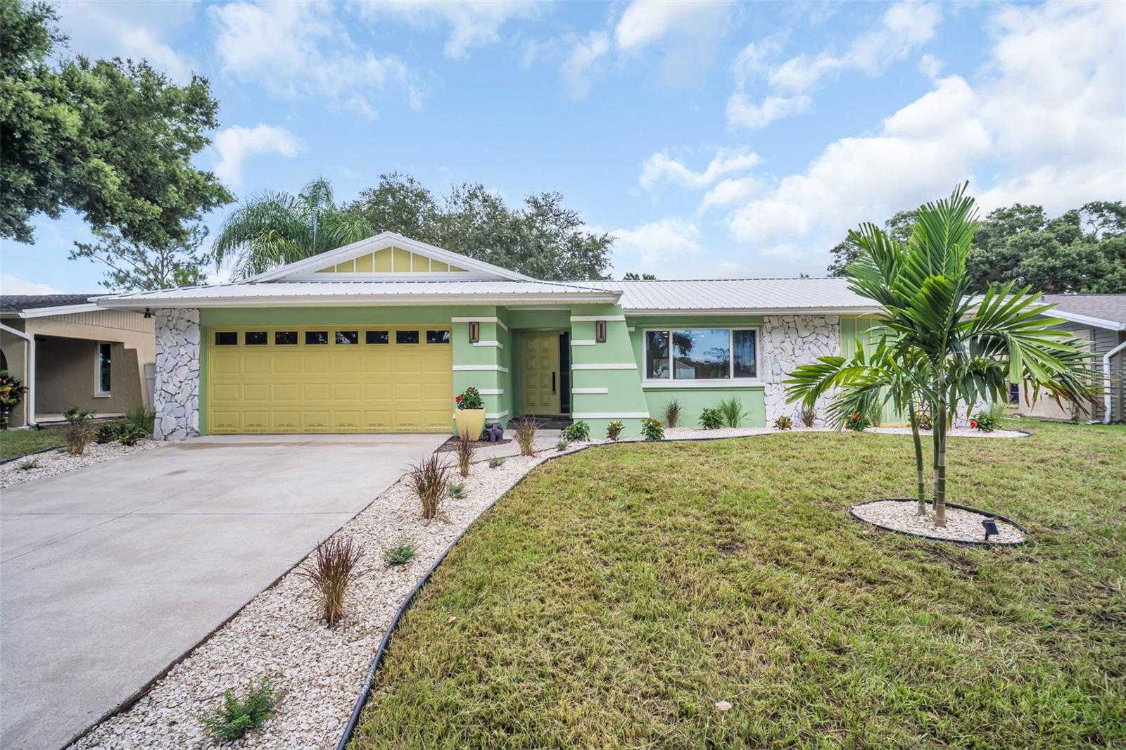 LOCATION.MAINTENANCE FREE.OPEN CONCEPT. Welcome to your dream pool home—a beautifully updated retreat offering 2,000 square feet of modern living with four bedrooms, two bathrooms, a spacious two-car garage and a backyard oasis. From the moment you step inside, the open floor plan and natural flow of the home set the stage for comfortable living. At the heart of it all is the stunning custom chef’s kitchen. Anchored by a generous island, this space features quartz countertops, custom cabinetry, and brand-new LG appliances—including an induction cooktop and convection oven—making it a true centerpiece for cooking, entertaining, and gathering with loved ones. Oversized windows overlook the backyard and sparkling pool, allowing natural light to pour in and creating the perfect backdrop for everyday living. The primary suite is its own private retreat, complete with a walk-in closet and a spa-inspired ensuite bathroom. Each of the bathrooms in the home has been thoughtfully remodeled with custom finishes, bringing a fresh and modern feel to every corner. Step outside and you’ll find your own backyard oasis. The pool has been resurfaced with PebbleTec and upgraded to a saltwater system in 2025, ensuring years of low-maintenance enjoyment. A brand-new vinyl fence frames the yard, offering both privacy and peace of mind, while new landscaping completes the picture. Even the details you don’t see every day have been carefully updated. In 2025, the home received a new four-ton Lennox HVAC, a new water heater and piping, an upgraded electrical panel with modern fixtures, fresh interior and exterior paint, and new luxury vinyl plank flooring throughout. A spacious laundry room with shiplap accents and a brand-new washer and dryer adds both charm and convenience. The exterior is topped with a durable metal roof installed in 2023, ensuring long-term peace of mind. For those who love to entertain, the spacious lanai offers the perfect setting to relax with friends and family while overlooking the pool, blending indoor comfort with outdoor enjoyment. With every major system thoughtfully replaced or upgraded, this home is truly move-in ready and maintenance-free for years to come. All that’s left to do is unpack, settle in, and start enjoying the lifestyle you’ve been dreaming of. Ranchwood Estates is in an optimal location with short drives to Downtown Dunedin, honeymoon island, beaches, parks, golfing, schools, shopping, churches, hospitals, malls and more. NO HOA, NO FLOOD ZONE