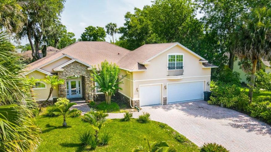 Stunning, custom executive home in Port Orange’s sought-after Riverwood Plantation.  Desirable school district. Corner lot & cul-de-sac location. Paver driveway & walkway leads to a gorgeous custom stone-accented exterior entry way.  Once inside, prepare to be impressed by this spacious home with amazing room to spread out.  Open floorplan with huge great room is perfect for a large family, extended family, a collector or those who love to entertain. This Rock Solid Construction built,  2005 home has 4 bedrooms, office/den, 3 baths downstairs master bedroom, 2nd master bedroom/playroom/hobby room over garage with 2 large closets, full custom slate tile bath.  The focal point of the great room is large built-in shelving system with room to hang a flat screen TV with electric heat fireplace below TV. French doors off the great room lead to private office/den. Engineered wood floors, crown molding, plantation shutters, tray ceilings with accent lighting, electric fireplace that heats, surround sound, custom shelving, triple sliders leading covered patio, central vacuum & more.  Huge gourmet chef’s dream kitchen with an abundance of cherrywood cabinetry with pullouts, granite counters, custom tile backsplash, center island with prep sink & seating for 4, built-in pantry,  granite counters, custom tile backsplash, all stainless appliances - Viking 6 burner gas range with double convection oven with griddle, Samsung commercial-style refrigerator, Viking microwave, wine fridge &Bosch dishwasher. Master suite offers large walk-in closet with built-in shelving, dual granite counter vanity, huge shower with 2 showerheads. Dine & entertain on the cover rear, pavered patio.  Gas hot water heater. Gas set up for dryer. Oversized, 3-car garage to store your “toys” This tranquil, tree-lined community offers a community pool, clubhouse, playground & a beautiful, private park overlooking Spruce Creek with dock/fishing pier & ramp for kayaks, canoes, paddle boards & smaller boats. ;Water: City