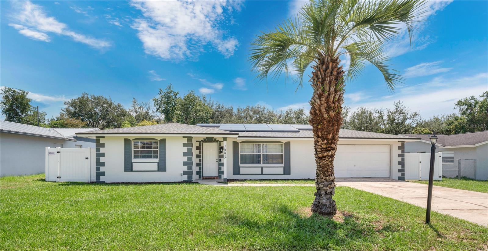 Big updates. Big yard. Breathing room. Set on nearly half an acre with no rear neighbors, this move-in-ready home nails both the essentials and the big-ticket items—starting with a brand-new roof (2024), fresh exterior paint (2025), solar panels (2021, paid off at closing), and a white vinyl privacy fence (2021) that wraps the backyard, offering a blank canvas for a future pool or whatever comes next. Inside, it’s bright, clean, cohesive, and low maintenance with tile flooring throughout and a layout that flows from a spacious living room into a kitchen that opens to both a large dining area and an eat-in nook with backyard views. Oversized sliders lead out to the screened-in lanai, already wired for a mounted TV—perfect for outdoor dinners or game day hangouts. The garage entry brings you into a generously sized laundry room that could easily be used a mudroom or drop zone. Both bathrooms have been updated, and the primary ensuite was completely redone in 2024 with a rainfall shower, frameless glass, and sharp finishes. Major system upgrades include a new electrical panel with generator hookup (2023), water softener (2020), water heater (2020), and AC (2017).
The location delivers, too! You’re just 30–35 minutes from both Orlando and the beach, with quick I-4 access and some of Central Florida’s best nature escapes close by. The Spring-to-Spring Trail, still expanding, will eventually connect Lake Monroe, Gemini Springs, and DeLeon Springs State Park—ideal for anyone chasing the Florida outdoor lifestyle. The updates are done. The space is here. And the next chapter is yours to write.