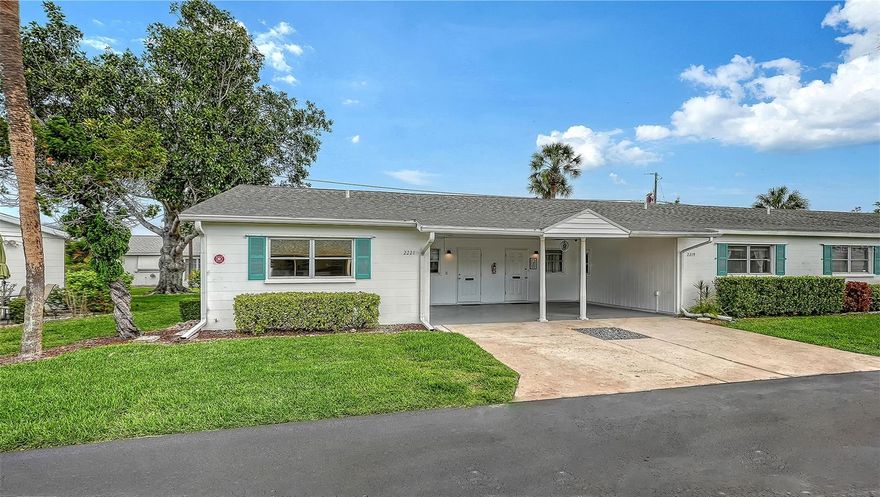 You will love this clean, bright and happily furnished end unit villa in Parkway Villas, a charming 55+ community with large heated pool, fun social get-togethers with music, food, and exercise classes, saunas, and shuffleboard, or just relax and enjoy the sunshine. Walk or ride your bike to Publix, TJMaxx, Target and great restaurants close by, or drive minutes away to Sarasota and Bradenton events, museums, shopping, beaches and nearby parks. The current owner has made it easy for you, with brand new stackable washer/dryer, water heater, luxury vinyl flooring in both bedrooms, and the bathroom and kitchen have newly raised ceilings. All new interior doors have been installed, plus new fans, light fixtures, freshly painted rooms, and popcorn ceilings have been removed for a clean, updated look. New interior blinds have unique sun and sound blocking qualities for luxurious afternoon naps and privacy. The cheery kitchen has been opened up to the dining and living room areas, and new quartz countertops and stainless steel sink were installed. Your 16' deep by 12'3" wide covered carport is at your front door, under roof for your protection, with a newly refinished epoxy floor Feb 2026. The outdoor back porch is 18'5" long by 12' with handsome brick pavers and built-in gardening areas for plantings and privacy bushes. The Florida room / lanai has sliding doors to the living room, and had a new roof installed in 2024. This one is truly special. Come see it today!