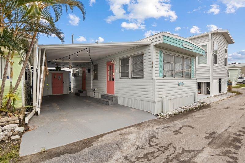 Sandpiper Resort is a 55+ coop community offering a prime location in the heart of Florida's famous and exclusive Anna Maria Island (AMI) at a very affordable cost. Enjoy as a great primary or 2nd residence and/or as a vacation rental that is always in demand. This upgraded and completely renovated move-in ready unit offered by a motivated seller has a roof over and is nestled between units on three sides for increased wind protection and has just completed a full $25k+ post storm renovation by a local GC (and listing agent) with all brand new equipment and appliances. This unit is unique as it has some core structural upgrades not found in other Sandpiper units. Full post storm renovation included city inspected complete electrical rewiring/breaker panel/outlets, new Daikin 12,000 BTU Mini-split A/C Heat Pump system, water heater, walls/trim/insulation, interior doors, Kenmore fridge, built in dishwasher, slim microwave, stovetop, dehumidifier, GE bedroom A/C. A previous $35k+ renovation in 2022 included replacing old RV honeycomb subfloor with a custom built home-grade subfloor (2x10 pressure treated joists strapped to 4x4 posts cemented & anchored, 3/4 plywood, Floor and Decor Optimaxâ„¢ commercial grade waterproof luxury vinyl, vapor barrier wrapping), renovated kitchen with Marble countertops, renovated Bathroom with Floor and Decor marble top vanity/fixtures, new American Standard toilet, renovated shower, new closet doors and slides, outdoor ceiling fan, unit and shed repainted painted with Sherman Williams paint, 3Mâ„¢ Safety & Security Window Film ballistic impact/UV protection recently added on all windows (2024). Full share with unit (appraised at $315k), structure appraised at $78k. Prepaid FEMA Flood Policy on unit good to 11/27.