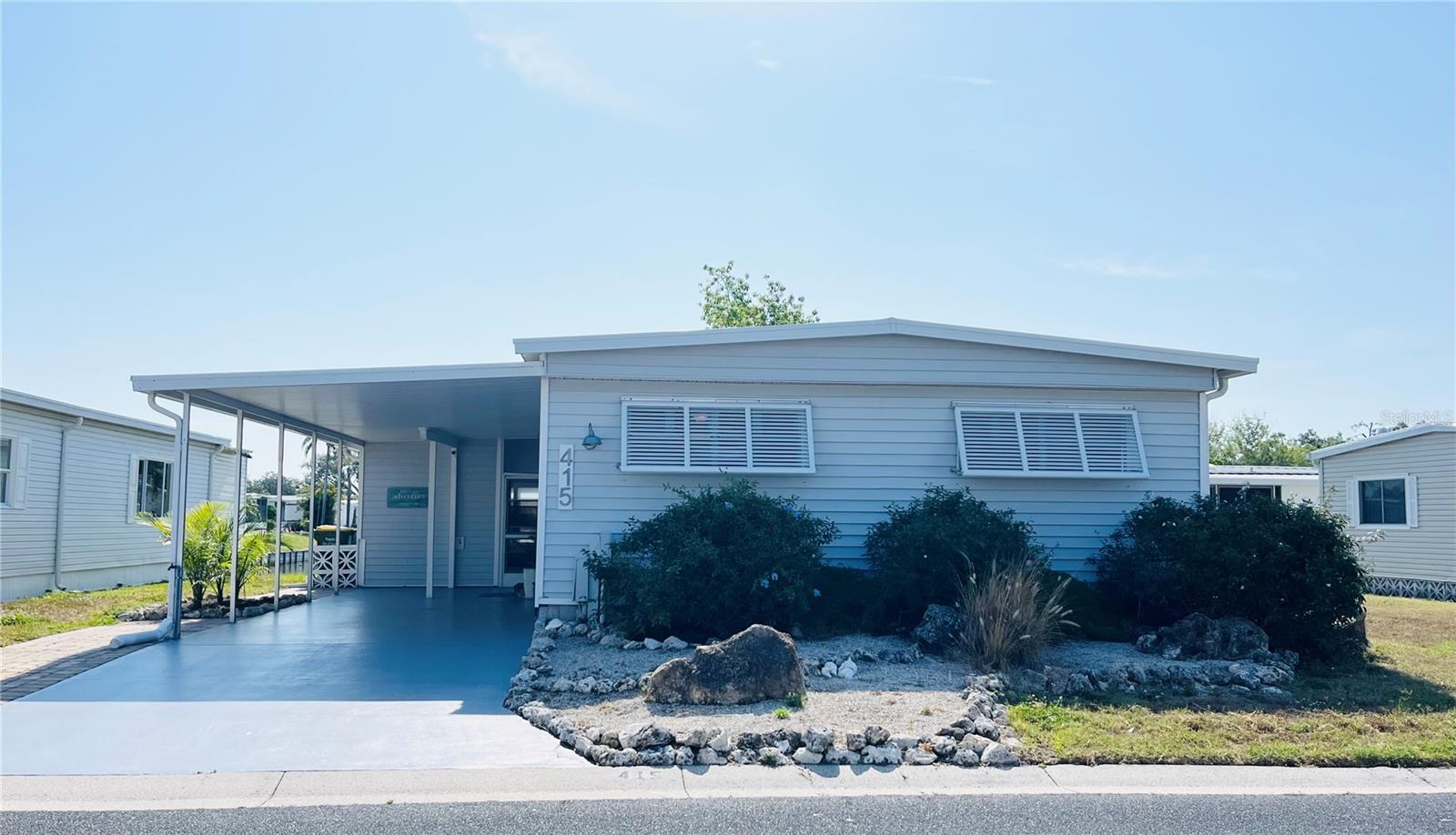 WATERFRONT home with fantastic views of the fountains and sunrise in the ONLY Resident Owned Park in the City limits of Sarasota!!
Welcome to this charming coastal themed UPDATED 2 bed 2 bath home with 1,160sf of living space plus a 236sf Florida room with AC (wall unit) that can be used year round. The open floor plan has a living area off the kitchen and a great room for dining and additional seating space that overlooks the water views. The open concept kitchen has a large island with a separate service sink with a reverse osmosis system and plenty of room for extra seating and entertaining guest. The cabinets allow for ample counter and storage space and the tile backsplash is a beautiful accent to the appliance package which includes a GE French door refrigerator 2024, Samsung self-cleaning range 2015, Samsung built in microwave 2015 and Samsung Smart dishwasher 2024. The primary suite has plantation shutters a large walk in closet and an updated bath with a 4ft walk in shower. The guest bedroom also has plantation shutters and is located just off the hall to the updated guest bath with a full size tub/shower.
Florida room has a tiki bar complete with a service counter, lighting and bamboo décor. The Bahama awnings around the outside of the home really dress up the coastal look, provide privacy without impeding the views and natural light. The awnings can be dropped to help give protection from storm debris. The washer is a 2023 and is located in the kitchen (which does have room to put a stackable in), the dryer is a 2015 and housed in the shed.
More Updates and notes: Main home metal roof over with 4" insulation installed 2018, Fl room rebuilt late 2024 to latest hurricane codes including the roof, windows, exterior door and lighting requirements. Water heater is 2015, Sewer line replaced, water lines are pvc with shut offs. Main living area floors are laminate, bedrooms have carpet, bath tile. All subfloors have been replaced.
Home is being sold with some furnishings (some furnishings pictured do not convey with the home).
The gated 90 acre community boasts a low maintenance fee with its vast amenities starting with the spacious Clubhouse outfitted with a full commercial cook kitchen, event stage, audio/visual, dance floor, state of the art fitness room, activities hall, library with books/movies/puzzles and a pool table. Outside recreation includes an extra large heated pool with a handicap ramp, a spacious kidney shaped hot tub, ample umbrella tables and lounge chairs and updated shower rooms. Oak trees shade the beautiful park area, picnic tables and a community grill. Additional amenities to enjoy are the community putt putt course, bocce ball, ping pong, horseshoes and corn hole. Oakwood Manor is a vibrant community with numerous social events and activities. Conveniently located adjacent to Legacy Trail and 12 newer pickle ball courts. Just a short drive to our crystal sand beaches, downtown area, the marina, fishing pier, local golf courses, shopping, variety of restaurants, the museum, SRQ airport, SMH and Doctors hospitals. Please note that Oakwood is a 55+, no pet, no motorcycle Park.