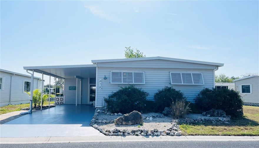 WATERFRONT home with fantastic views of the fountains and sunrise in the ONLY Resident Owned Park in the City limits of Sarasota!! 
Welcome to this charming coastal themed UPDATED 2 bed 2 bath home with 1,160sf of living space plus a 236sf Florida room with AC (wall unit) that can be used year round. The open floor plan has a living area off the kitchen and a great room for dining and additional seating space that overlooks the water views. The open concept kitchen has a large island with a separate service sink with a reverse osmosis system and plenty of room for extra seating and entertaining guest. The cabinets allow for ample counter and storage space and the tile backsplash is a beautiful accent to the appliance package which includes a GE French door refrigerator 2024, Samsung self-cleaning range 2015, Samsung built in microwave 2015 and Samsung Smart dishwasher 2024. The primary suite has plantation shutters a large walk in closet and an updated bath with a 4ft walk in shower. The guest bedroom also has plantation shutters and is located just off the hall to the updated guest bath with a full size tub/shower.
Florida room has a tiki bar complete with a service counter, lighting and bamboo décor.  The Bahama awnings around the outside of the home really dress up the coastal look, provide privacy without impeding the views and natural light. The awnings can be dropped to help give protection from storm debris. The washer is a 2023 and is located in the kitchen (which does have room to put a stackable in), the dryer is a 2015 and housed in the shed. 

More Updates and notes:  Main home metal roof over with 4" insulation installed 2018, Fl room rebuilt late 2024 to latest hurricane codes including the roof, windows, exterior door and lighting requirements. Water heater is 2015, Sewer line replaced, water lines are pvc with shut offs. Main living area floors are laminate, bedrooms have carpet, bath tile.  All subfloors have been replaced. 
Home is being sold with some furnishings (some furnishings pictured do not convey with the home).

The gated 90 acre community boasts a low maintenance fee with its vast amenities starting with the spacious Clubhouse outfitted with a full commercial cook kitchen, event stage, audio/visual, dance floor, state of the art fitness room, activities hall, library with books/movies/puzzles and a pool table. Outside recreation includes an extra large heated pool with a handicap ramp, a spacious kidney shaped hot tub, ample umbrella tables and lounge chairs and updated shower rooms. Oak trees shade the beautiful park area, picnic tables and a community grill. Additional amenities to enjoy are the community putt putt course, bocce ball, ping pong, horseshoes and corn hole. Oakwood Manor is a vibrant community with numerous social events and activities. Conveniently located adjacent to Legacy Trail and 12 newer pickle ball courts. Just a short drive to our crystal sand beaches, downtown area, the marina, fishing pier, local golf courses, shopping, variety of restaurants, the museum, SRQ airport, SMH and Doctors hospitals. Please note that Oakwood is a 55+, no pet, no motorcycle Park.