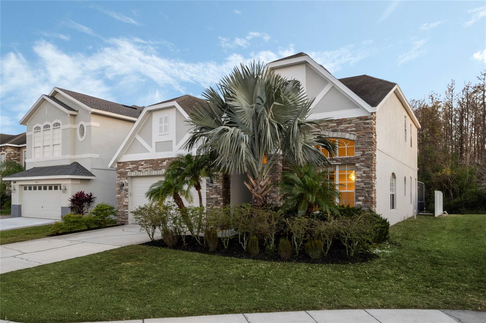 Experience the pinnacle of luxury living in this exquisite 5-bedroom, 4-bath estate in the gated Sandhill Preserve community near Lake Nona, where rows of palm trees line the entrance and each home features its own, creating a resort-like charm. Located within this private, palm-lined community, the home welcomes you with undeniable curb appeal—a 5-car driveway, lush landscaping, and a signature Bismarckia palm. Inside, soaring 24-ft ceilings, architectural windows, and a bright, airy layout create a truly enchanting atmosphere, where sunlight peeks into every corner and nature is always within view. The gourmet kitchen with brand-new stainless steel appliances, 20+ deluxe 42" cabinets, a 10-seat breakfast bar, and custom cabinetry flows effortlessly into the family room and out to the screen-enclosed, heated pool and spa area—offering year-round enjoyment, especially in the tranquil winter evenings when the illuminated water and forest backdrop feel like a personal retreat. Wake up each morning to birds chirping from the private wooded preserve, visible right from your bedroom window or while enjoying breakfast in bed. Hosting is a dream from the open-concept kitchen and lanai, where lush greenery, pool views, and a natural Zen ambiance make every gathering magical. The home includes two primary suites (one on the main floor), an upstairs loft/lounge, Jack-and-Jill bath, and no rear neighbors with 20 ft of extra yard space for privacy. For those interested in Feng Shui, the entrance faces North, inviting harmony and energy flow into the home. All updates were completed in 2024/2025, including a new Trane Heat Pump with Wi-Fi Control System and Carrier Heat Pump Wi-fi Control System. Other updates include a brand-new electronic keypad smart lock system (code/fingerprint/key), stylish hardwood flooring, new staircase, luxury wood floors in master bedrooms and second floor, pool resurfacing with new tiles, deck repainting, sealed brick pavers, irrigation system, updated patio/pool screens, interior and exterior professional painting, new stainless steel appliances (range, refrigerator, microwave, dishwasher), new kitchen sink/faucet, new toilets, faucets, and ceiling lights, new dining room chandelier, crystal fan with remote, Wi-Fi garage opener, new moldings, epoxy garage floor, new closet doors and shelving, new exterior garage light fixtures (2), and refreshed landscaping. The heated pool and spa, powered by a high-efficiency heat pump, provide year-round enjoyment. Just 10 minutes to Lake Nona Medical City, 15 minutes to the airport, and 20 minutes to Disney and SeaWorld, the home is also moments from Starbucks, Publix, restaurants, and everyday essentials. With low HOA, no CDD, and community amenities including a playground, this home offers a rare combination of elegance, privacy, smart upgrades, and unbeatable location—schedule your private tour today!