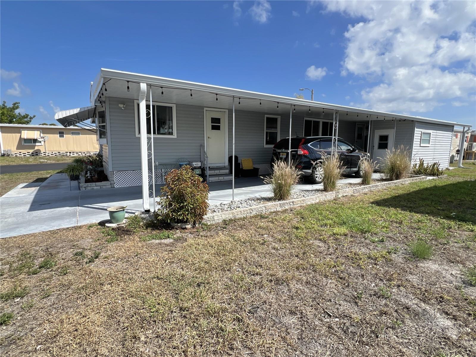 Annual rental. 55+ community. Spacious 2 bed/2 bath home with more than 800 sq ft of living space plus a 200 sq ft Florida room to use as office/hobby or extension of living area. Large carport with utility shed makes the entire property more than 1,800 sq. ft. Boat on trailer is allowed to be park in carport. If you're paying for boat storage, this is a great way to get on the water and not have to travel to a boat ramp. The home had no flooding inside with 2024 storms and has been well maintained. Features include 2017 HVAC system with 2024 ductwork, 2022 water heater, 2025 roof, 2024 vapor barrier to protect subflooring, 2024 plumbing and 2022 electrical box. Laminate flooring throughout. Split bedroom plan. Spacious living room with lots of windows makes the home bright. Washer inside with dryer in shed. Located on large corner lot. Home is located in popular 55+ waterfront community with many amenities including heated pool, fitness center, clubhouse, two boat ramps and kayak launch and so much more. Rental fee is $1,300 per month, which includes water/sewer/trash pick up/lawn mowing/24 hr manned gate/pest control and the amenities. Electricity and cable/internet are paid by renter. Two dogs or cats up to 35 pounds are welcomed; two pets total per household. $100 deposit per pet required. Deposit of $1,300 required when signing rental agreement. A great retiree rental at a very affordable price! Only 10 mins to downtown St. Petersburg, 15 mins to two airports and 25 mins to beaches!
