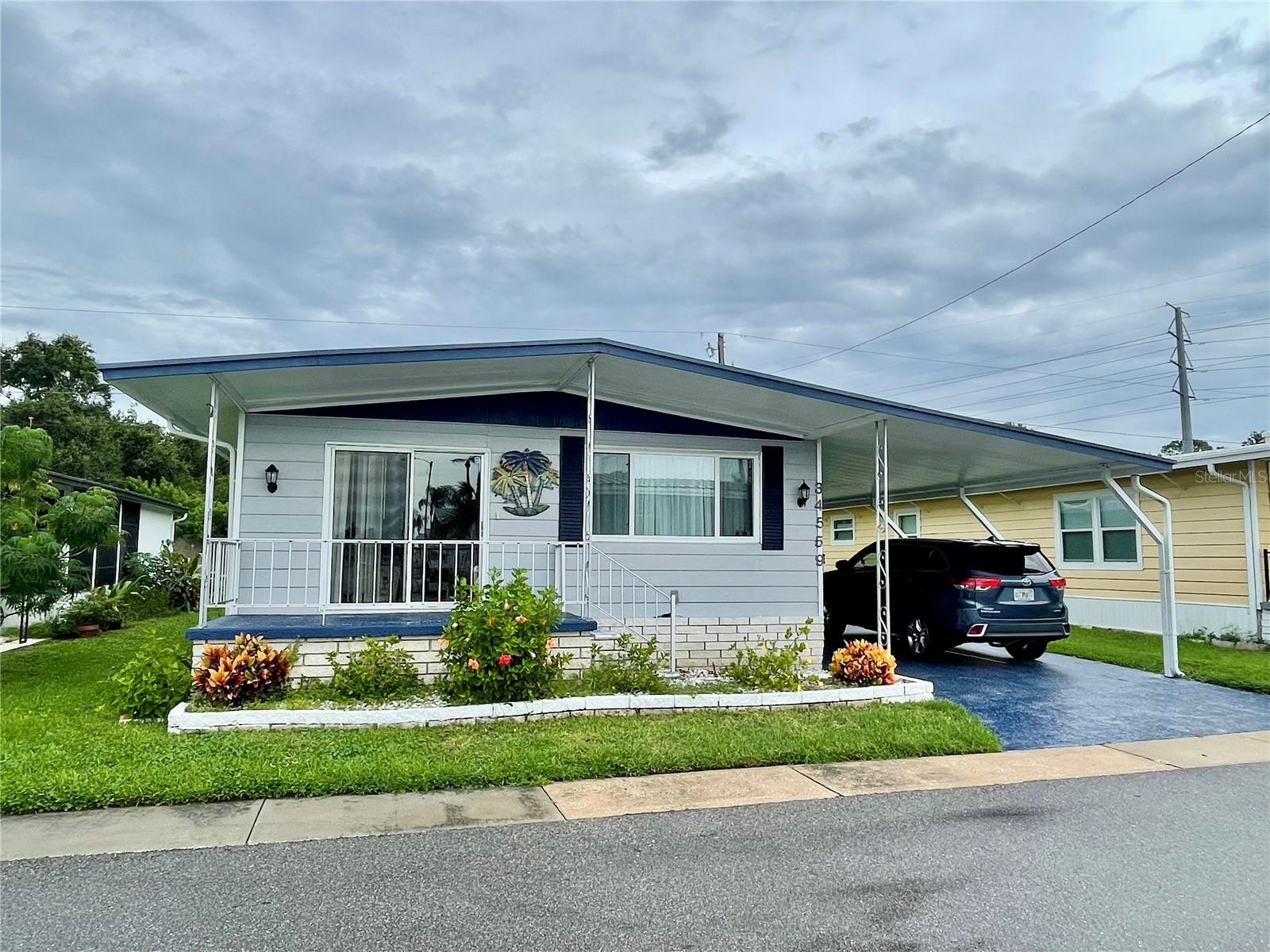 Come check out this beautifully remodeled and fully (nicely) furnished home with a TRUE coastal vibe! This home has been meticulously maintained, Roof - 12/2024, AC - 2019, kitchen, Water-softener, Luxury vinyl plank flooring, some doors, most of the windows, fresh paint, some lighting, hardware thru-out, etc, etc have all been updated in the last couple of years. This list price DOES include the SHARE valued at $55,000.00, and ONLY $183.05 per month which includes WATER, SEWER, and TRASH, owned clubhouse, escrows are fully funded, beautiful heated pool and spa, fitness center, library, shuffleboard, billiard table, grounds maintenance, and a small lake at the back of the park, laundry room, and your very own private entrance to the super Walmart… on foot, bicycle or golf cart… Etc., etc. Sunset Palms is in close proximity to the beaches, airports, I – 275, churches, restaurants, all kinds of shopping, etc.…