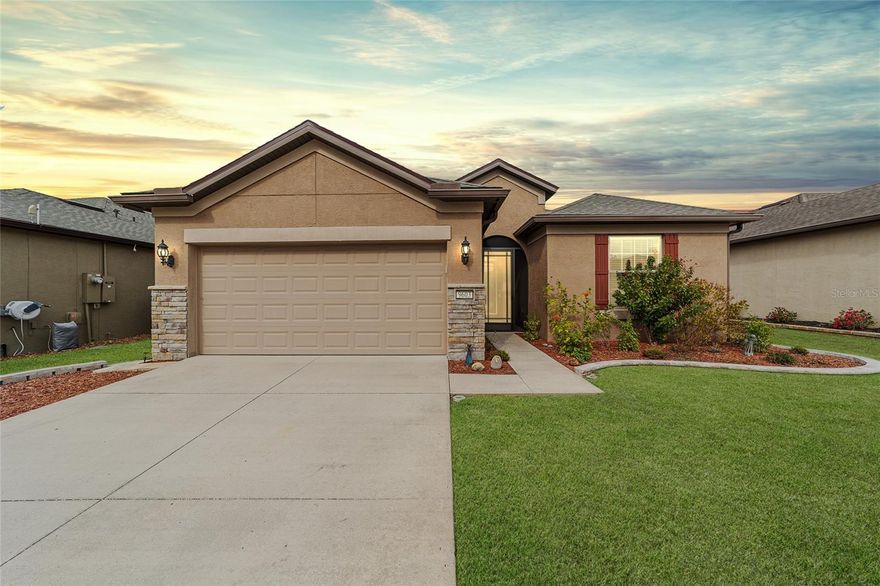 Enjoy relaxed living in this beautifully designed 2-bedroom, 2-bath Summerwood model complete with a bonus flex room located in the gated 55+ Stone Creek Golf Course Community, offering a wide variety of resort-style amenities. Set on a premium lot with serene, green space views, this home welcomes you with exceptional curb appeal created by eye-pleasing landscaping, stacked stone accents, and a screened entryway that offers a pleasant spot to welcome visitors. Inside, the versatile and open layout is designed for easy living with volume ceilings, LED downlighting, upgraded five-inch baseboards, and diagonally laid tile flooring throughout for a clean and elegant look. The bonus flex room adds valuable space for a home office, den, or hobby room, and the extended garage provides excellent room for a workshop or golf cart. The chef’s kitchen has been thoughtfully designed with flawless details, including an upgraded stainless steel appliance package with a vented range hood, tiled backsplash, granite countertops, and a large walk-in pantry for extra storage needs. The large center island with designer pendant lighting offers comfortable seating for casual dining and extra room for meal preparation. The gathering room opens to a north-facing screened lanai and birdcage patio through wide pocket sliders, creating a seamless indoor and outdoor living experience. This peaceful outdoor living area overlooks a quiet green space that provides beautiful views and a sense of privacy, perfect for morning coffee or afternoon relaxation.The owner’s suite is a calming retreat with serene greenspace views and a tray ceiling that adds a touch of elegance. The suite includes a generous walk-in closet and a spa-inspired bath with a Roman-style walk-in shower, a transom window that brings in natural light, a seating ledge, a granite-topped comfort-height double vanity, and a private water closet. Practical upgrades enhance daily convenience, including overhead storage racks in the garage and additional outlets and lighting in the lanai, garage, and kitchen. The home is also pre-plumbed for a water softener, and the laundry room includes upper and lower cabinetry, a folding counter, and a utility sink to keep chores simple and organized. Step beyond this thoughtfully designed home into a vibrant community where every day feels like a retreat. With 24/7 gated security, Stone Creek offers peace of mind and a lifestyle rich in comfort and connection. Enjoy resort-style amenities including heated pools, a full-service spa, pickleball, tennis, and bocce. A dedicated lifestyle team curates engaging events, while the nearby golf course, pro shop, and on-site restaurant provide the perfect setting to unwind and socialize. Make your move today and experience an ideal blend of elegance and active living.