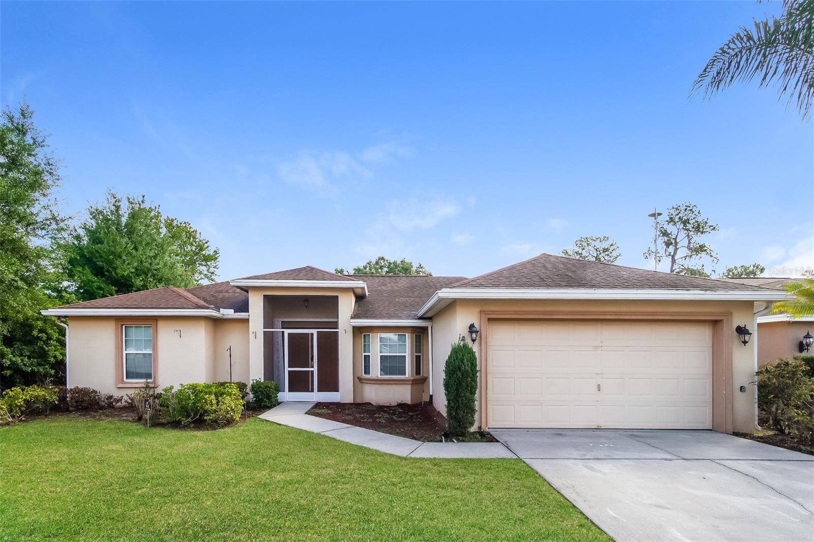 Charm and curb appeal abound for this Winter Haven home! Step inside into the inviting entry and into well-appointed living room, which is positioned at the center of the home. Through the dining room you'll find the kitchen, which boasts stainless steel appliances, hard surface countertops, and ample storage. Rounding out this ranch style floorplan is the primary suite, two secondary bedrooms, and a laundry room. Enjoy your covered sunroom and private, enclosed backyard all year long. Come and see for yourself the possibilities that this home has to offer!